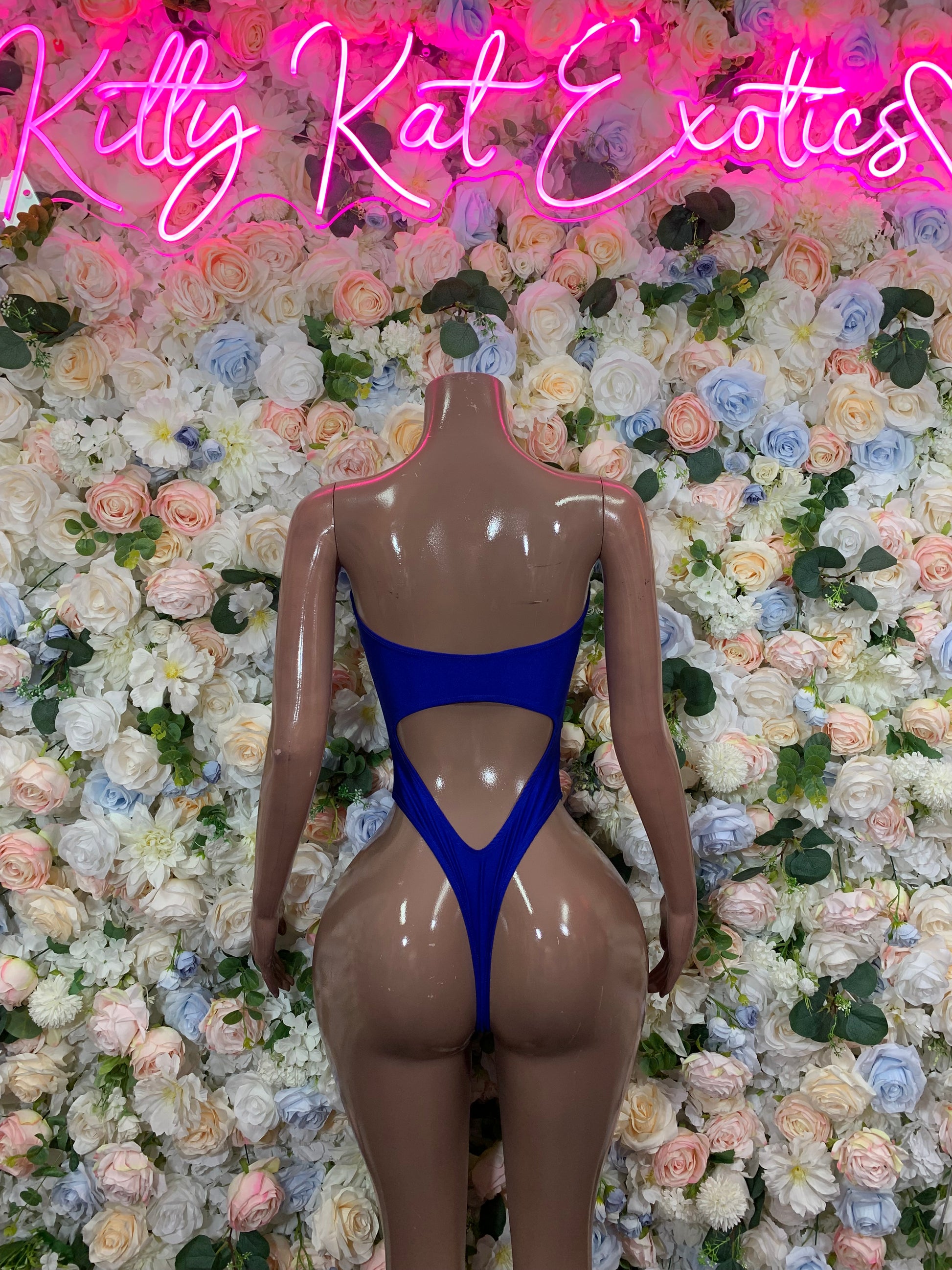 Blue one-piece bodysuit with deep V front cutout and strappy back