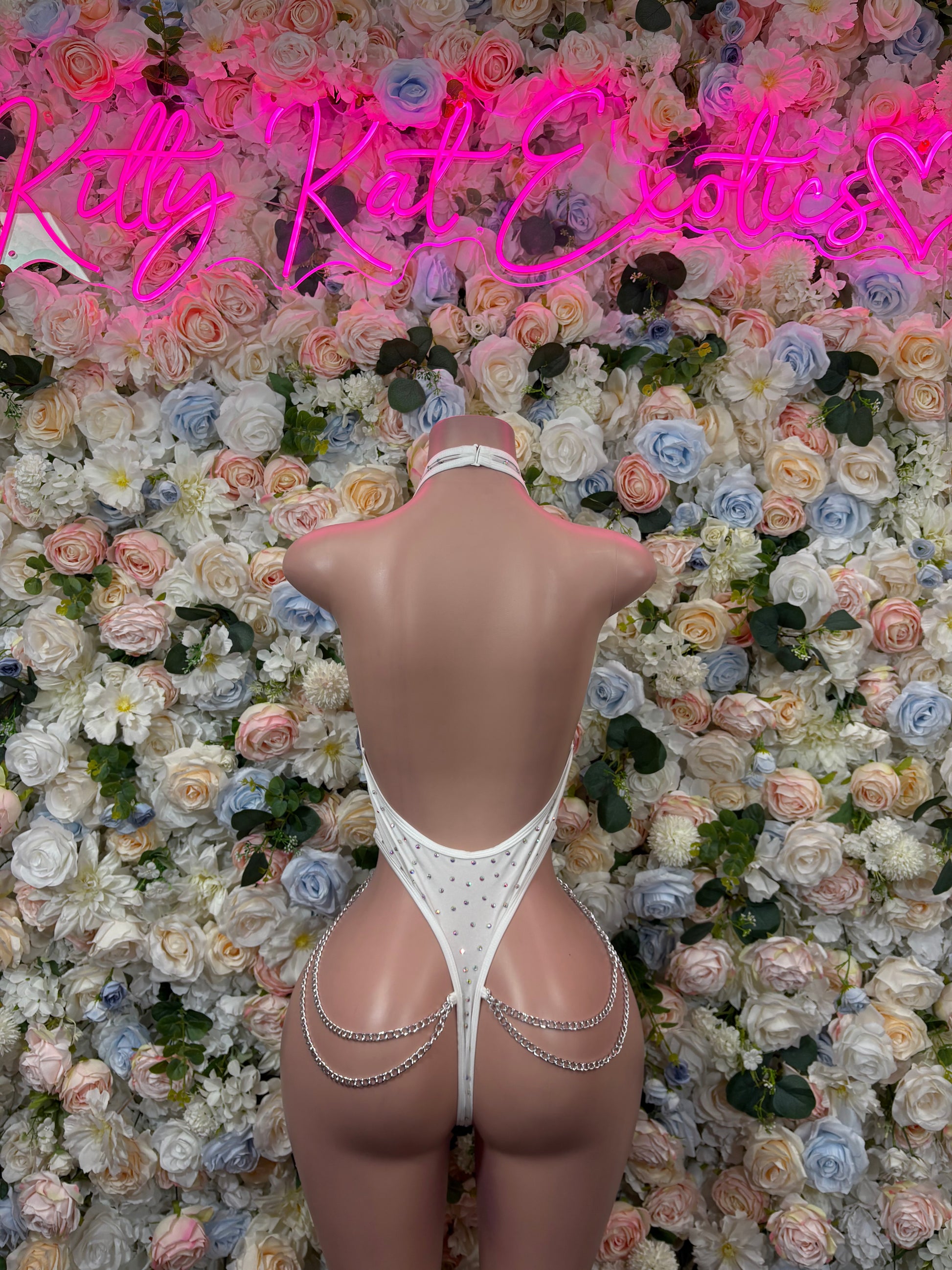 White rhinestone fishnet bodysuit with chainlink straps, open back