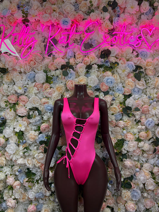 Pink one-piece bodysuit with crisscross lace-up front and high-cut legs