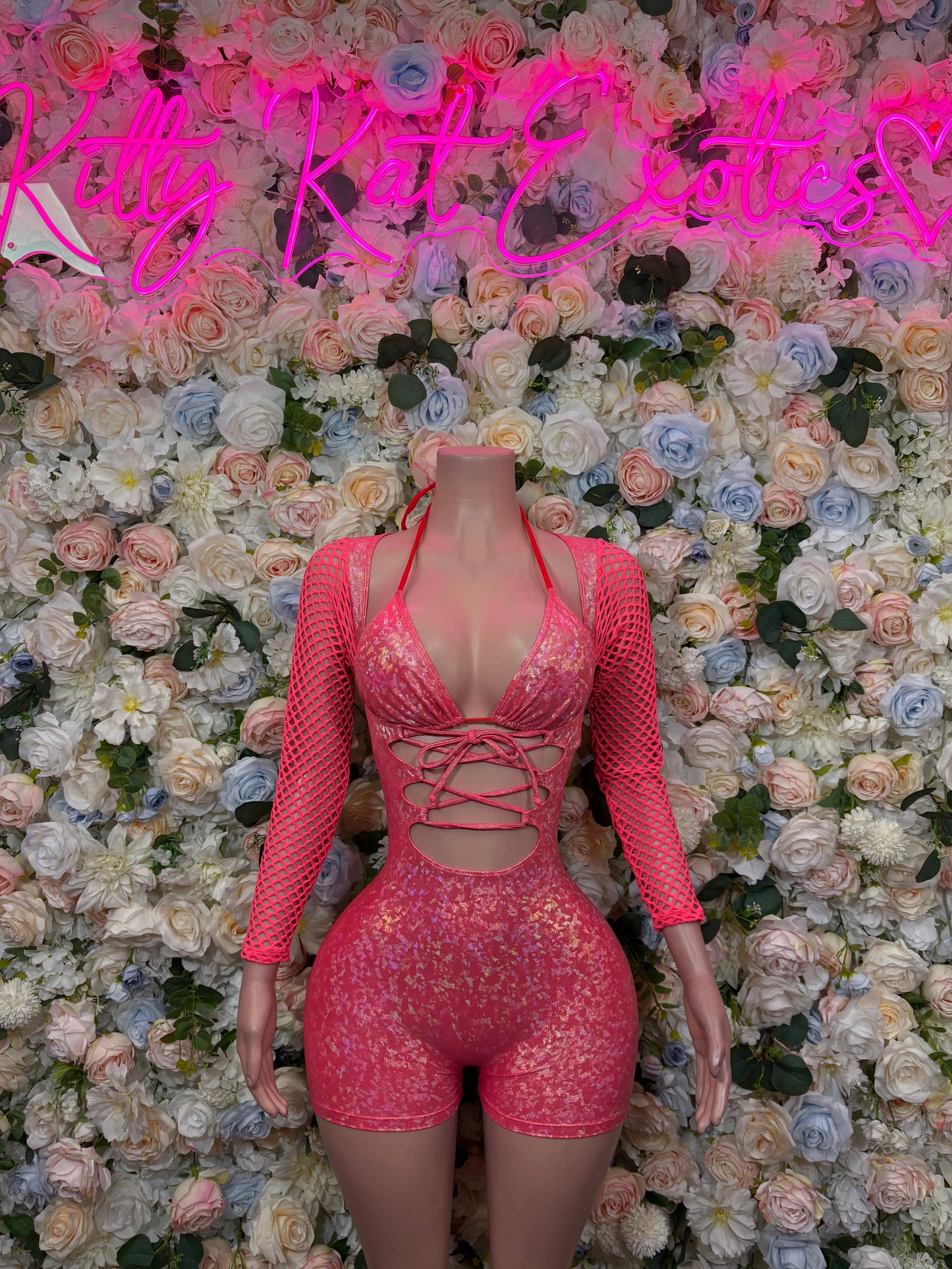 Pink metallic long-sleeve bodysuit with crisscross front lace-up and high-cut shorts