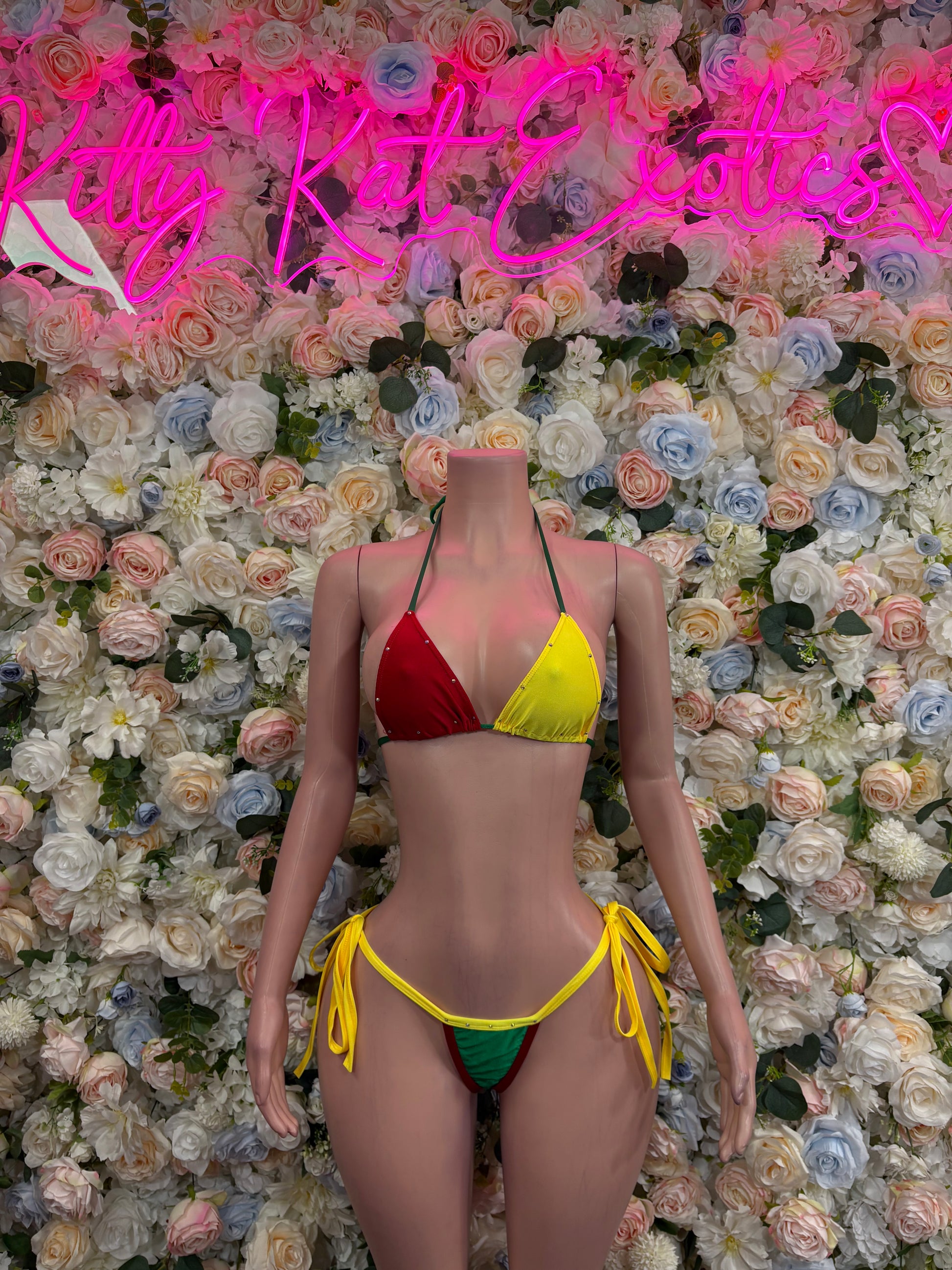 Bikini swimsuit with red top, yellow and green triangle accents, string ties