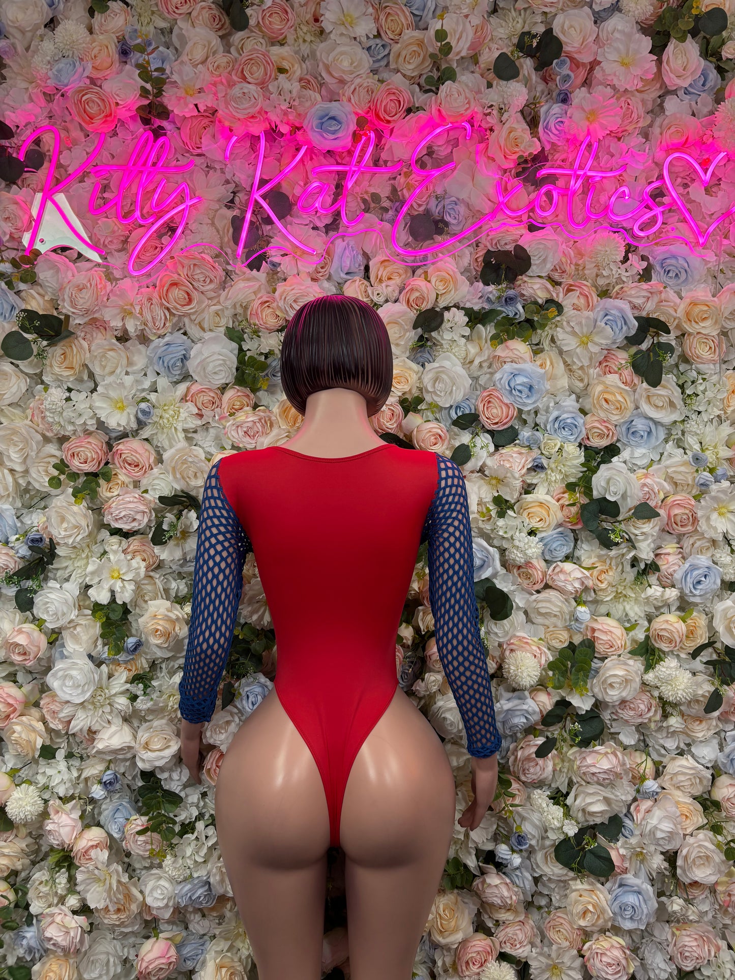 Red back-view bodysuit with blue mesh long sleeves and white front lace-up ties