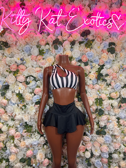 Women’s referee-style costume on mannequin: sleeveless striped crop top and black pleated skirt