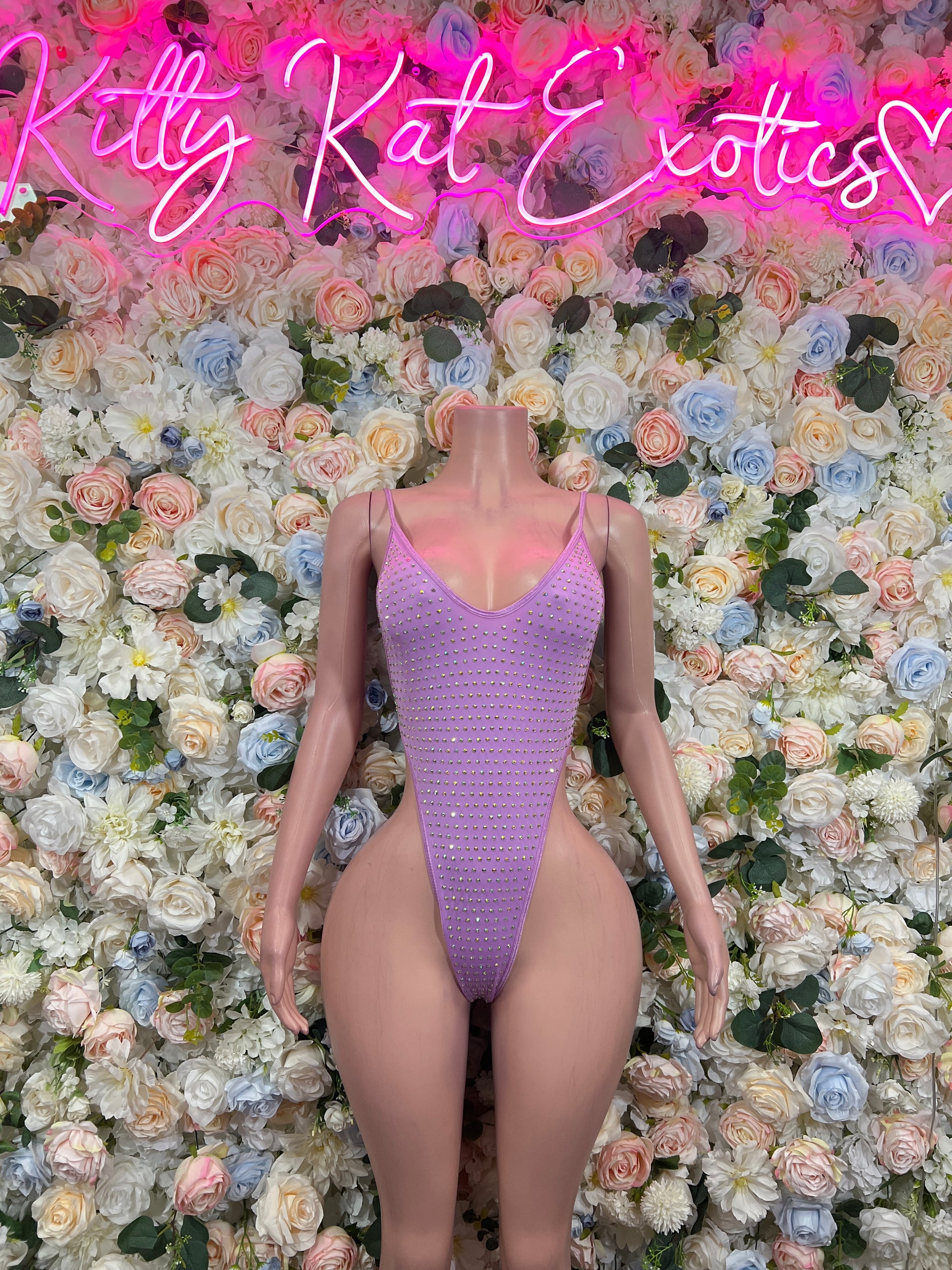 Lilac rhinestone one-piece bodysuit with V-neck spaghetti straps on mannequin