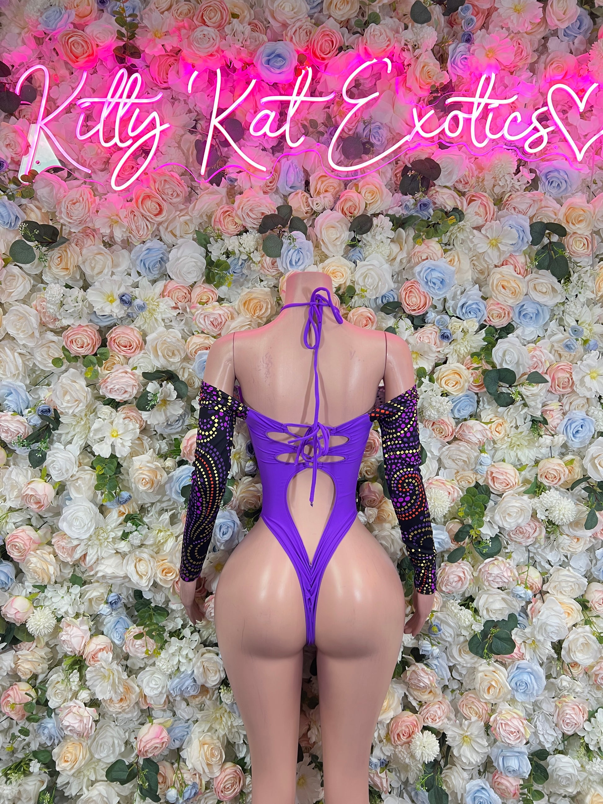 Purple bodysuit back view with crisscross straps and open back