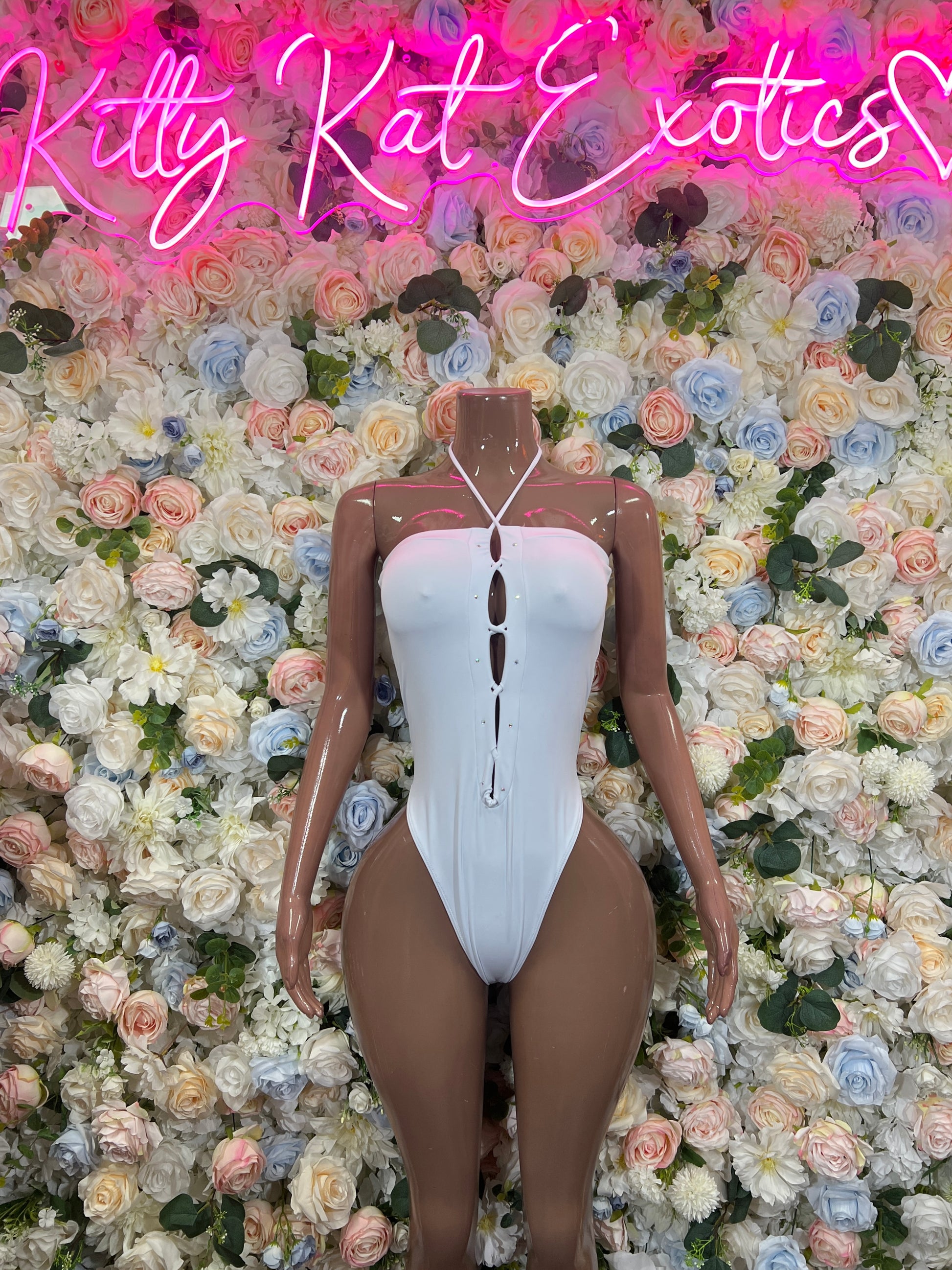 White high-cut bodysuit with vertical cutout and lace-up front