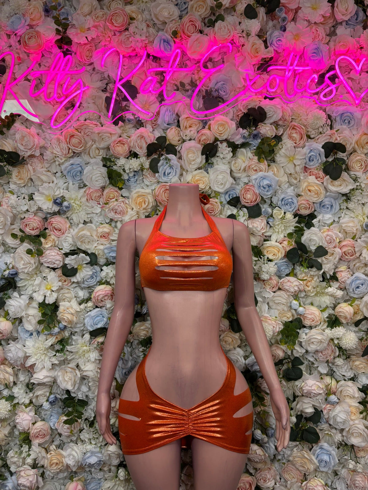 Copper orange cutout slingshot bodysuit with glossy halter neckline and hip cutouts