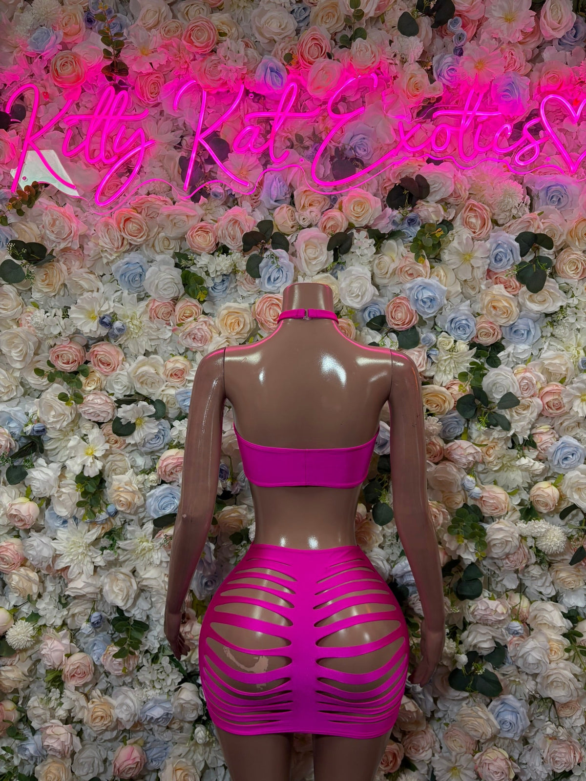 Back view of hot pink strappy cutout mini dress with banded cutouts