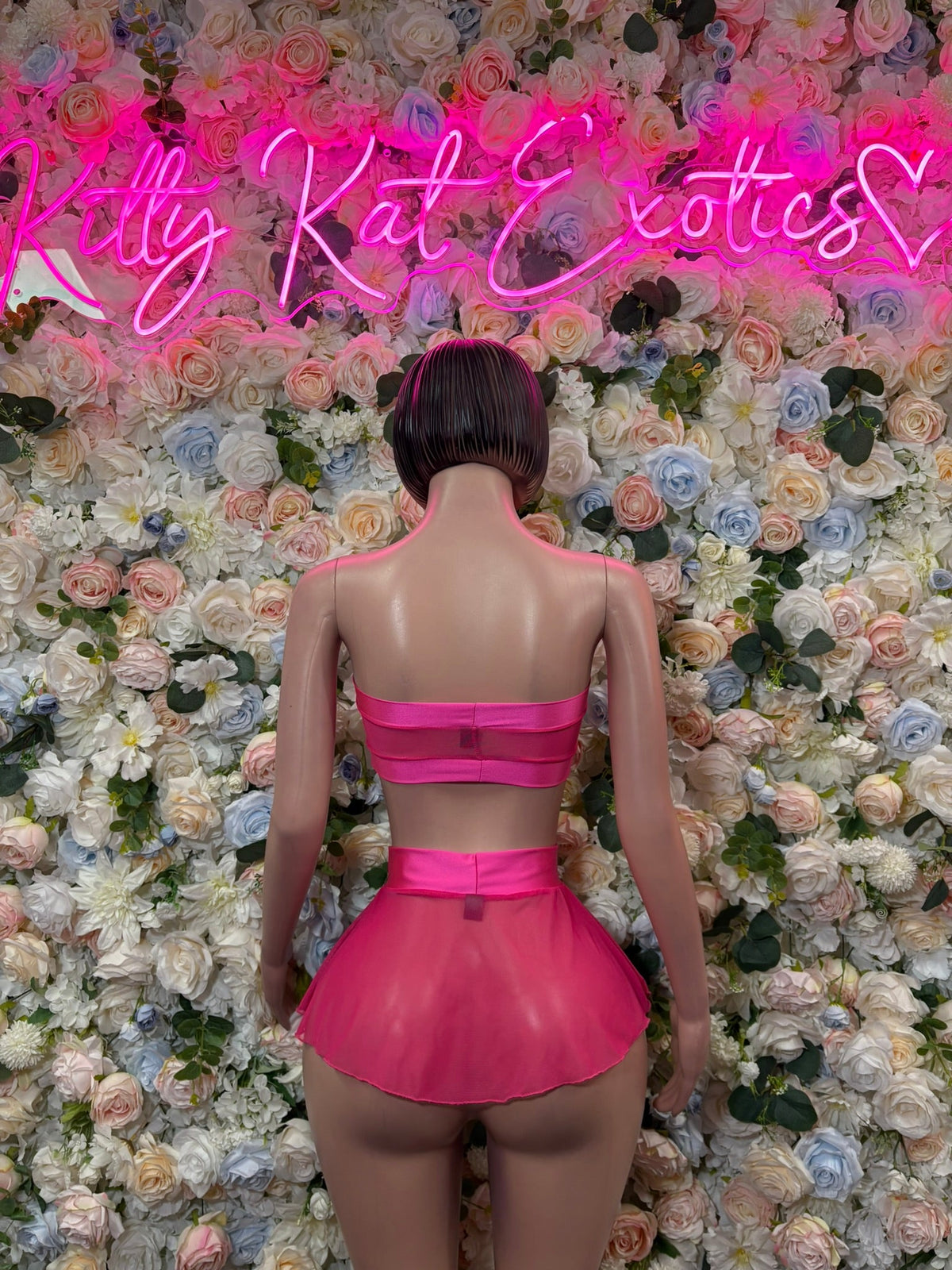 Hot pink ruffle mini skirt set with halter back straps and bow detail, rear view