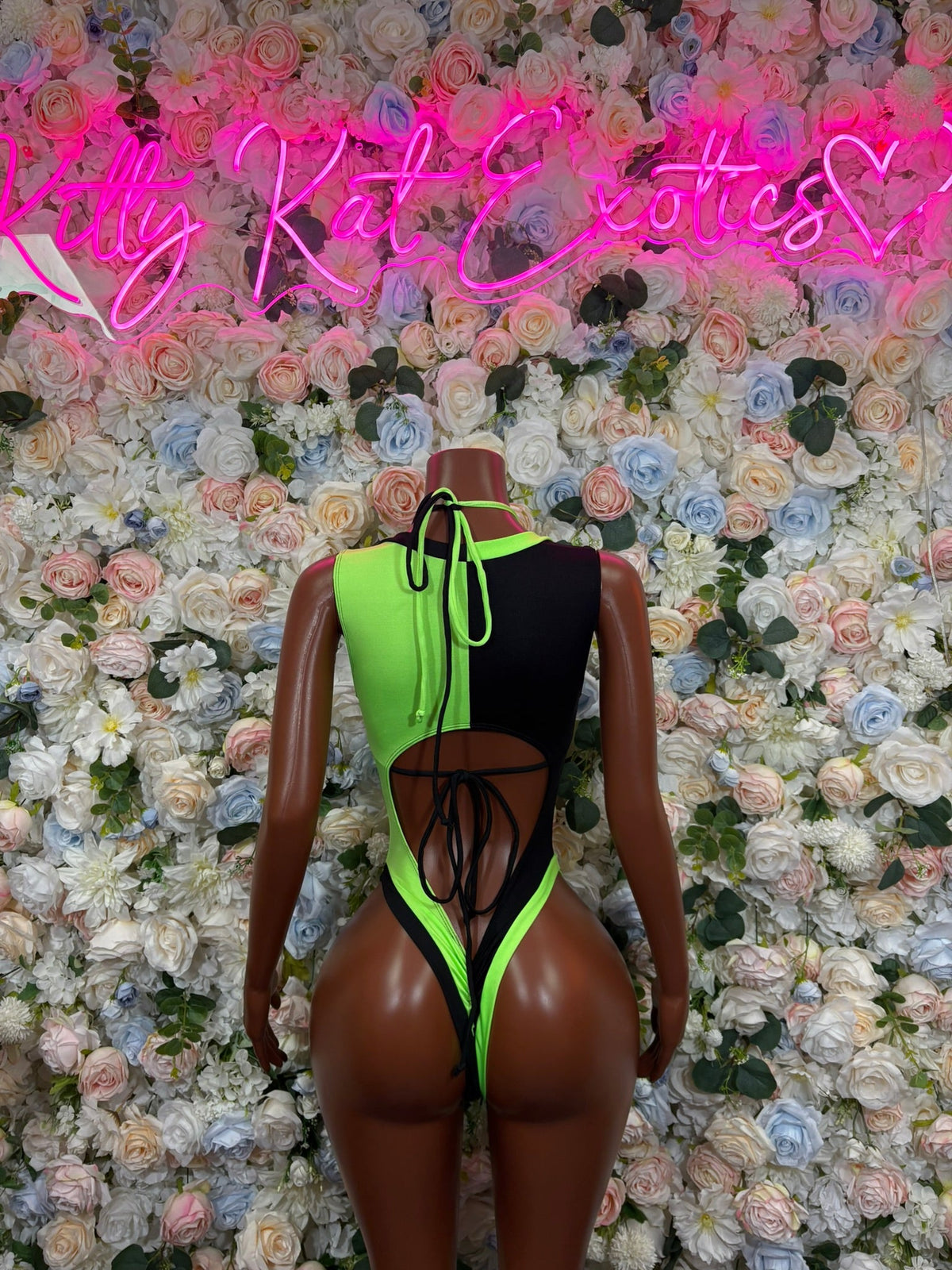 Neon green and black colorblock bodysuit with back cutout and high-cut thong design