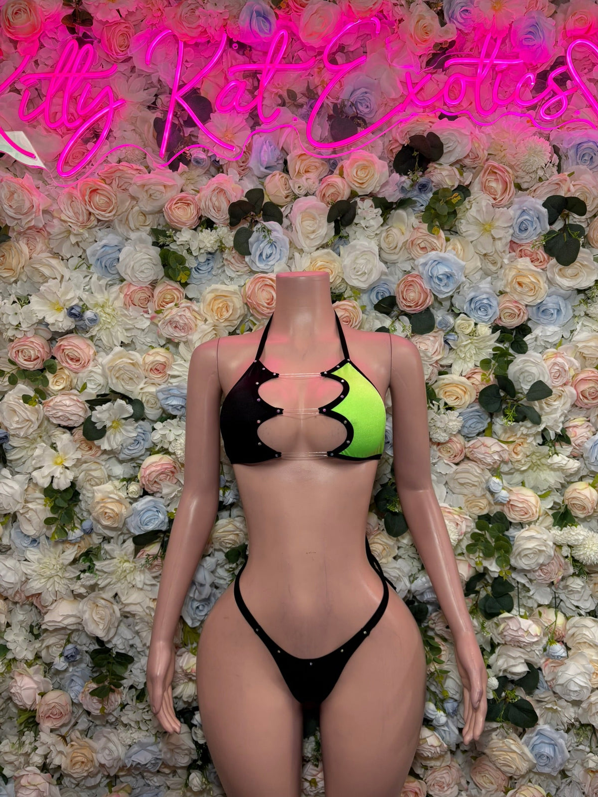 Two-tone slingshot bodysuit, black front with neon green triangle panel and straps