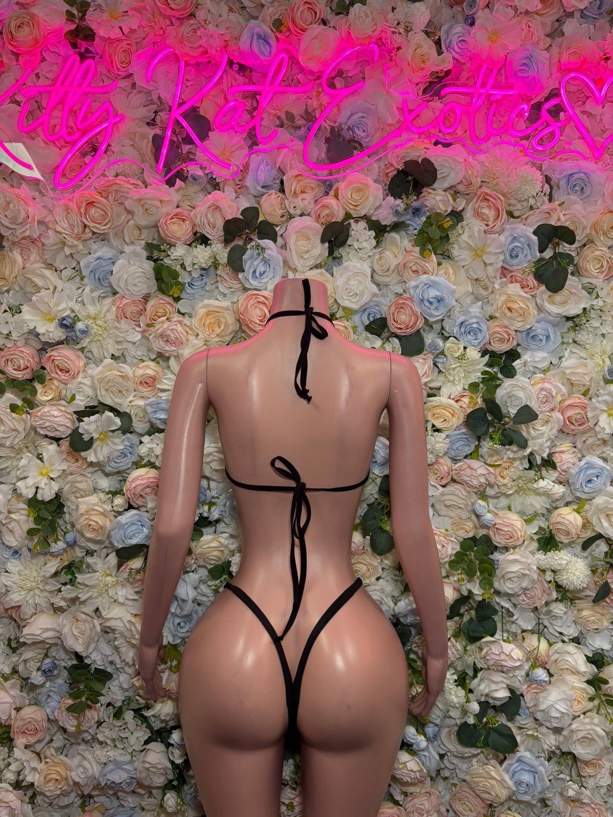 Two-tone slingshot bodysuit, black back view with neon green accents