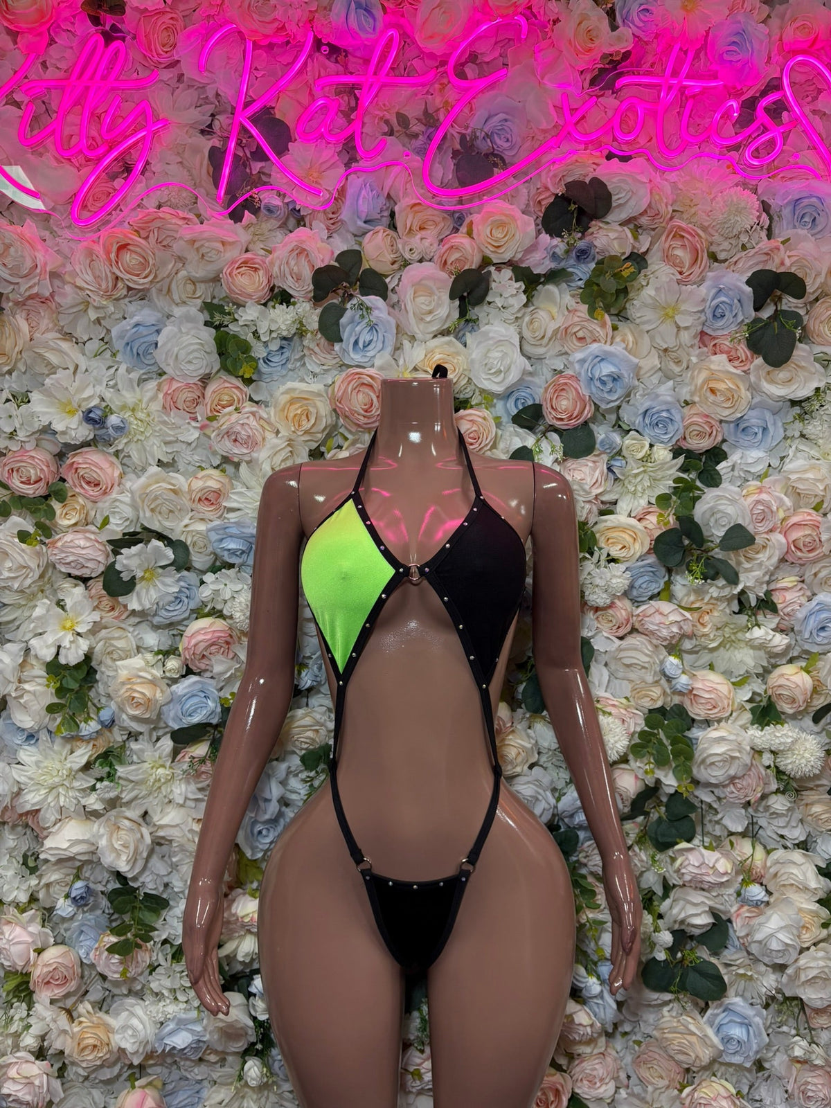 Black plunge bodysuit with neon green front panels and thin tie straps