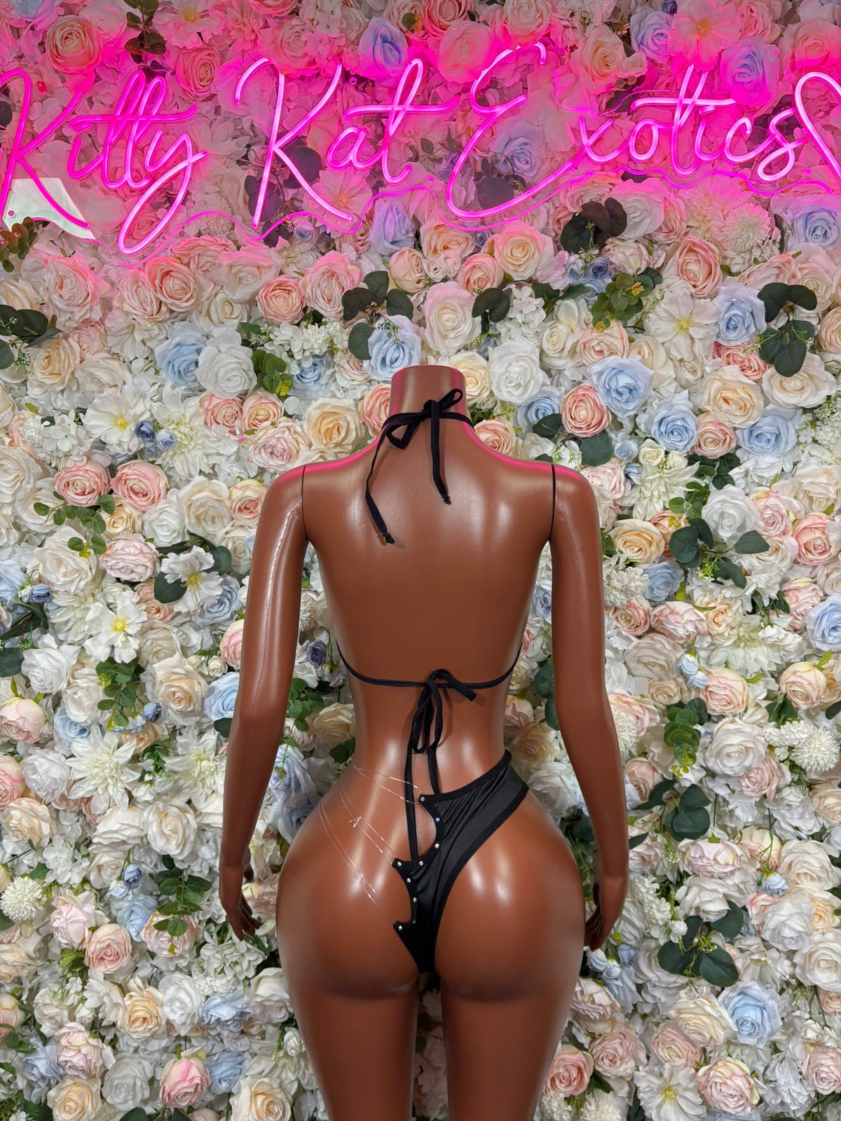 Backless halter slingshot bodysuit with neon green and black graphic print ties