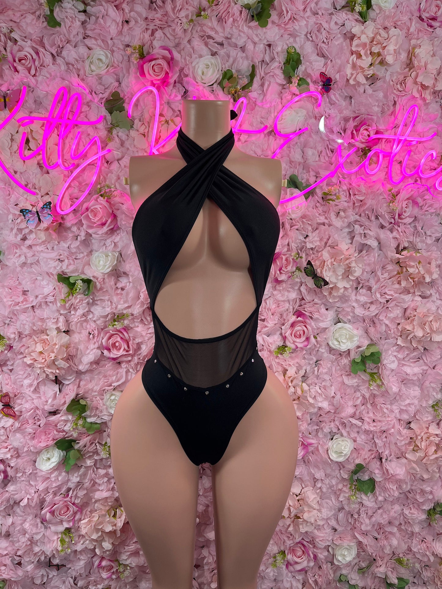 Black halter one-piece bodysuit with cross-front straps and oval chest cutout