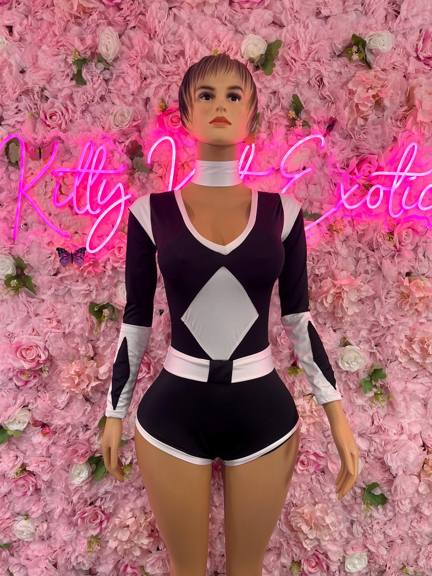 Women’s black and white long-sleeve bodysuit with V-neck and diamond panel