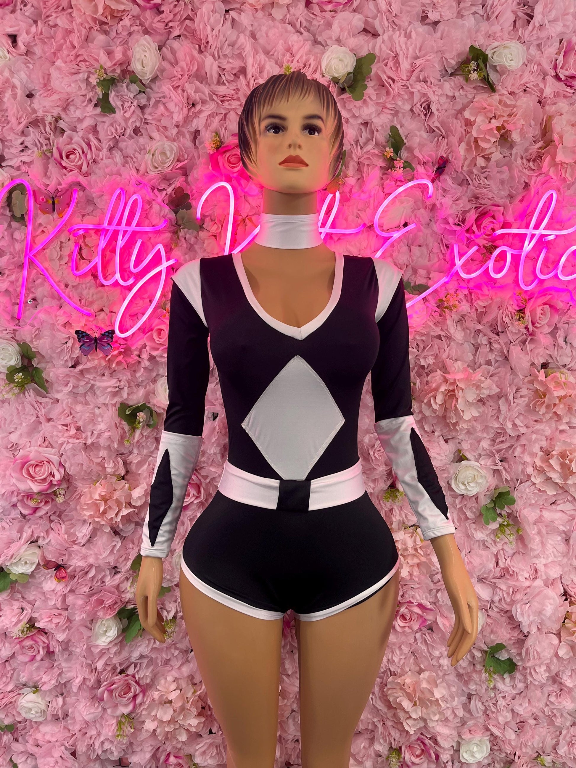 Women’s black and white long-sleeve bodysuit with V-neck and diamond panel