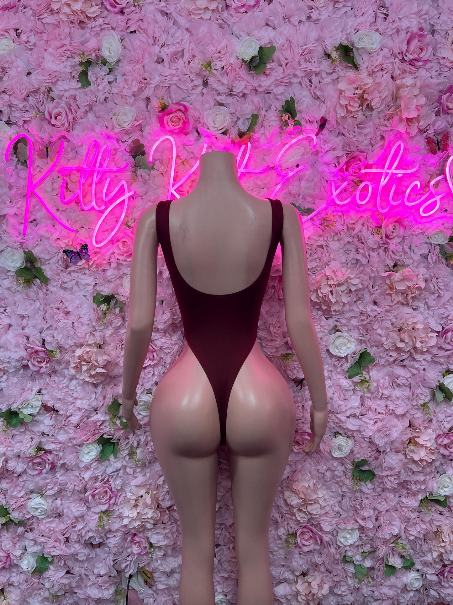 One-piece bodysuit in dark red with open scoop back and halter-style straps