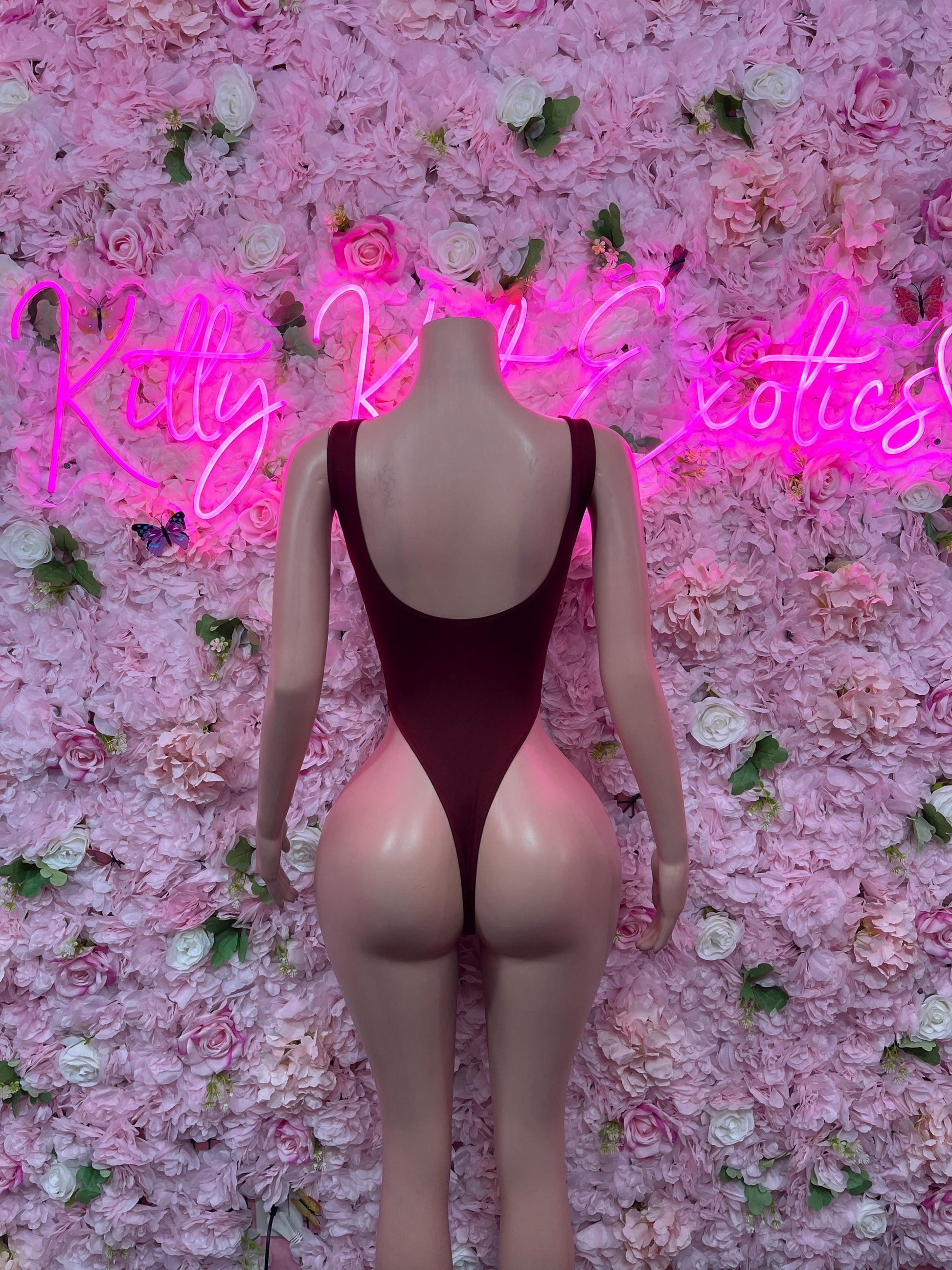 One-piece bodysuit in dark red with open scoop back and halter-style straps