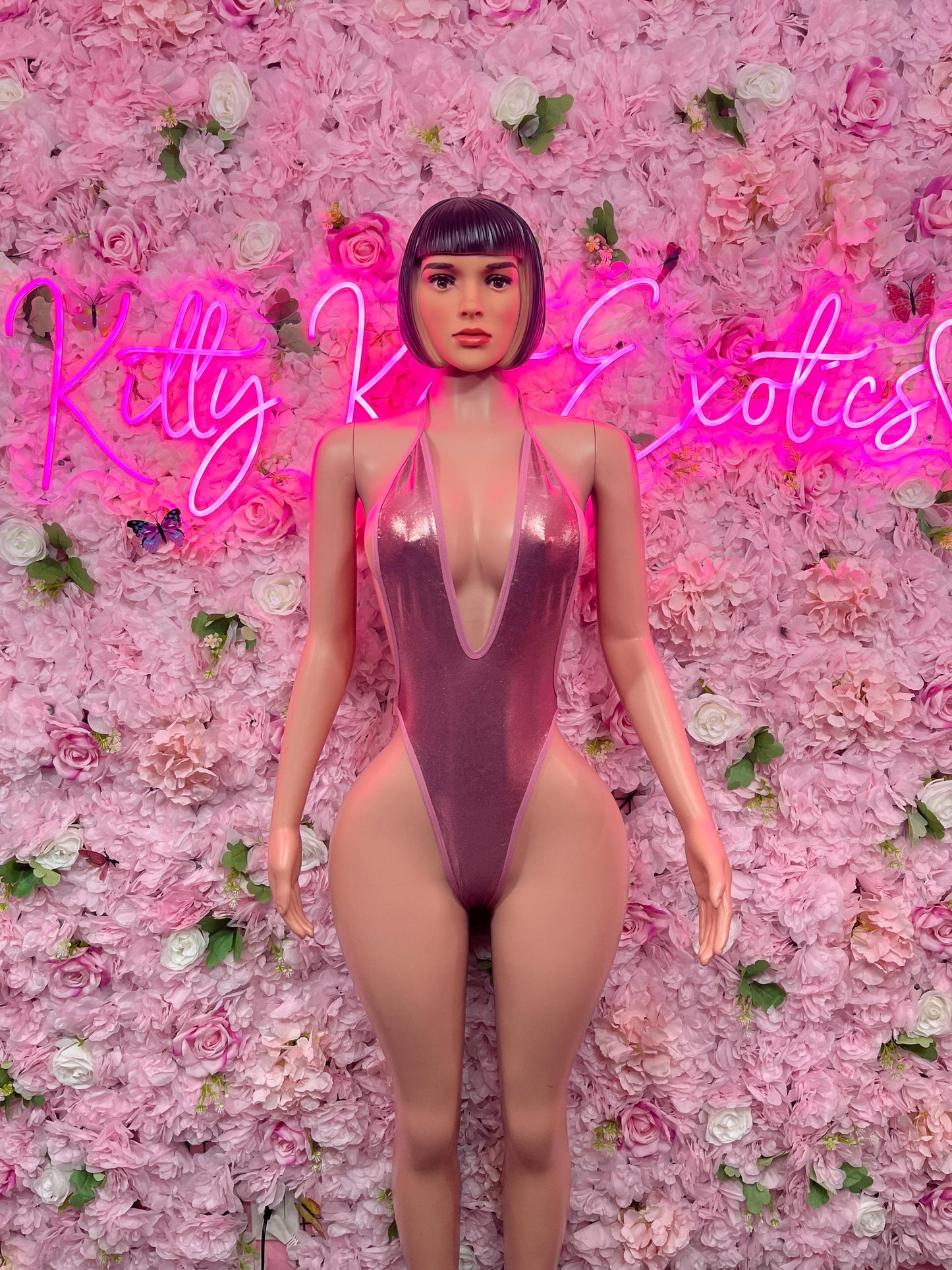 Pink one-piece dance bodysuit with deep V neckline and high-cut legs, sleeveless