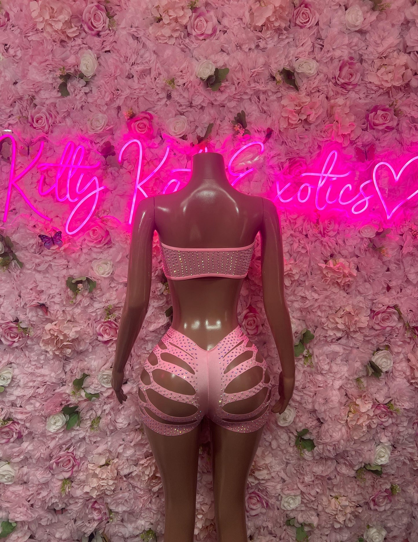 Pink rhinestone two-piece dance costume, back view with cutout shorts and bra