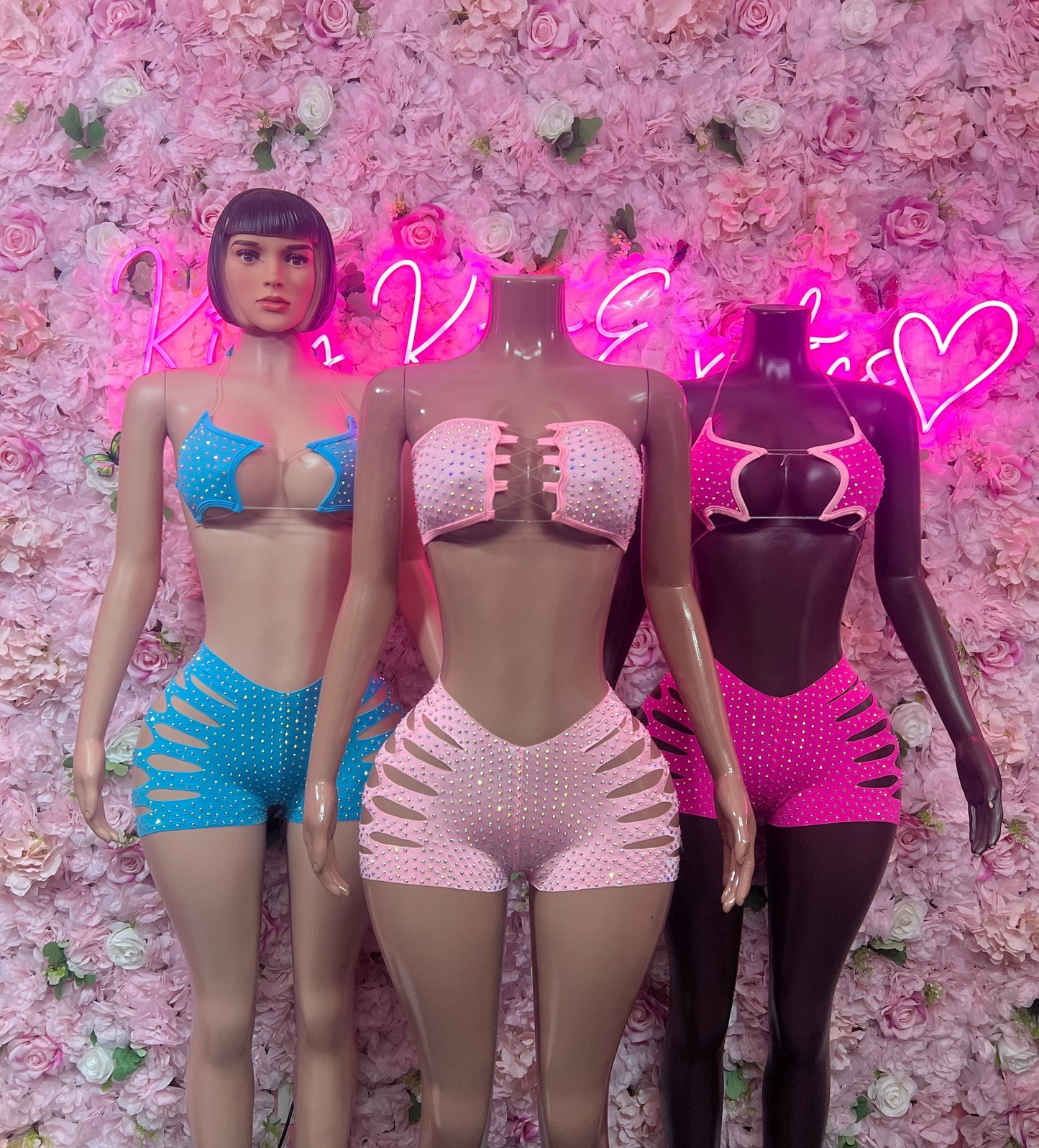 Rhinestone two-piece dance costumes in blue, pink-white, and black with cutout shorts