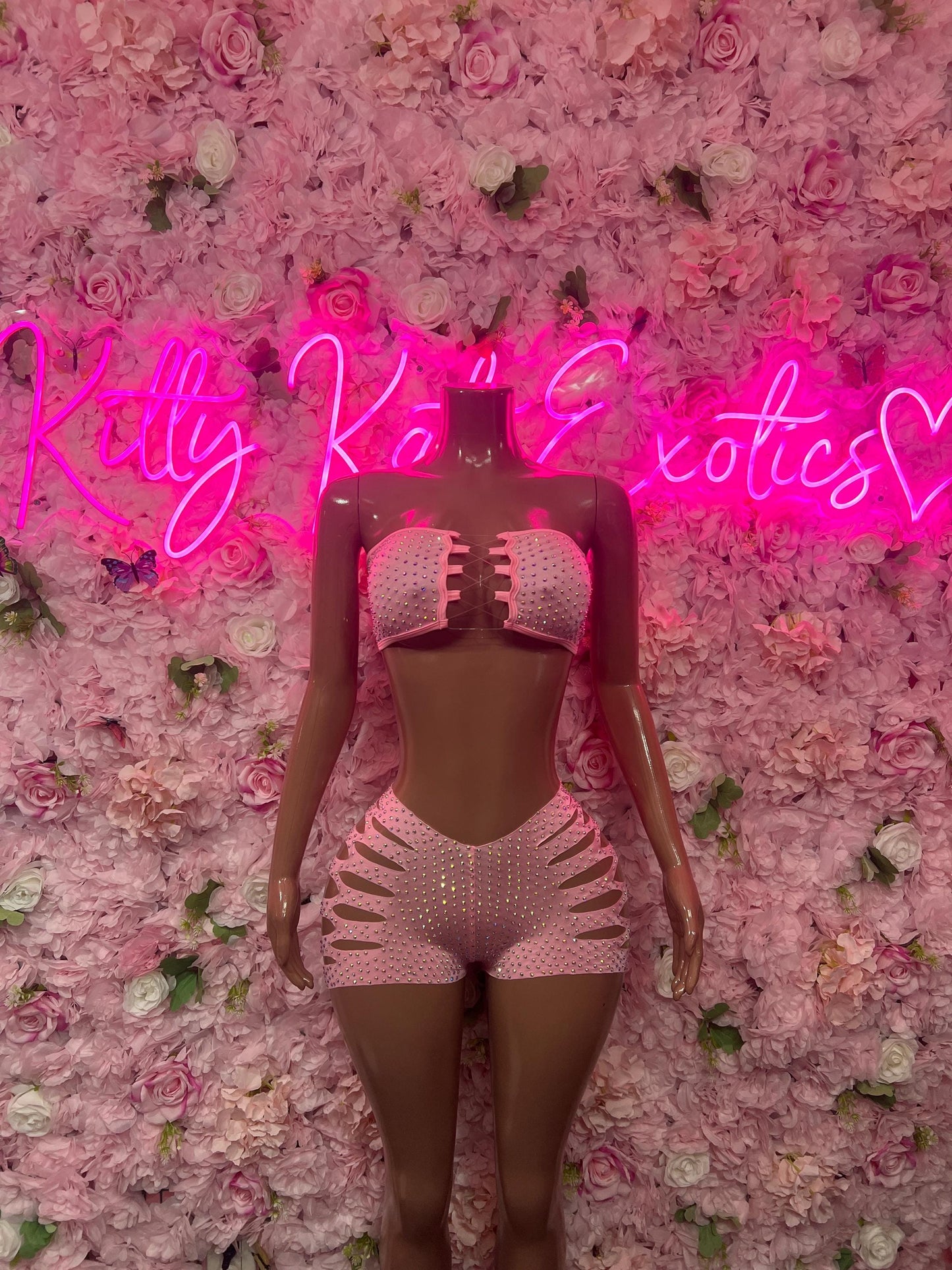 Pink rhinestone two-piece dance costume with cutout shorts and matching bra top