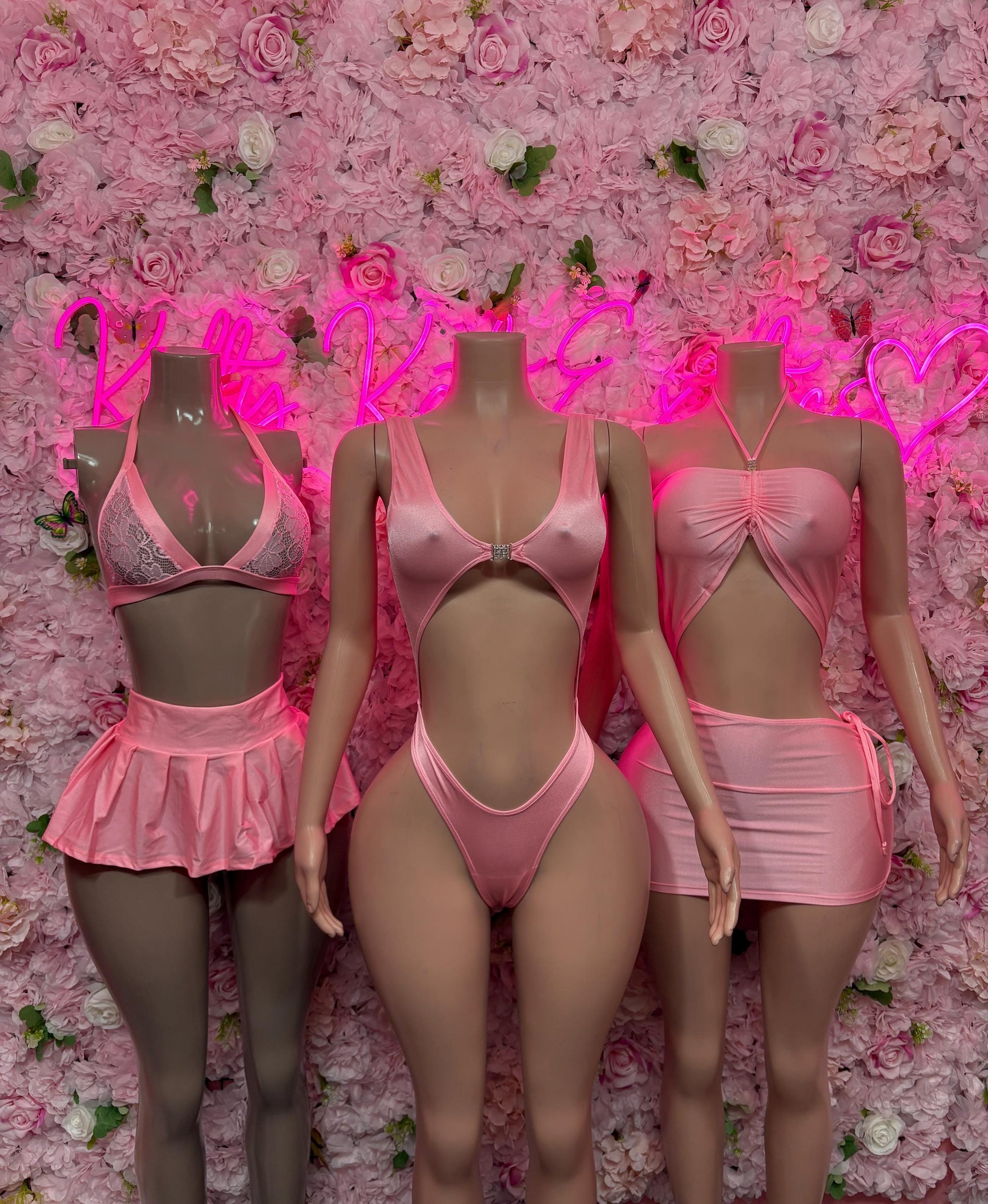 Set of pink and dark mini dancewear dresses and bodysuits on three models