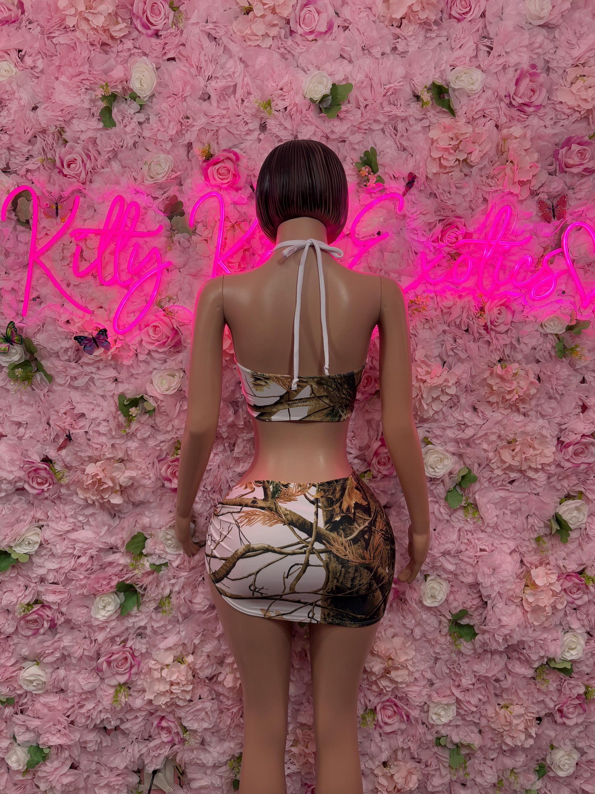 Back view of camo-print dance two-piece set with halter tie and mini skirt