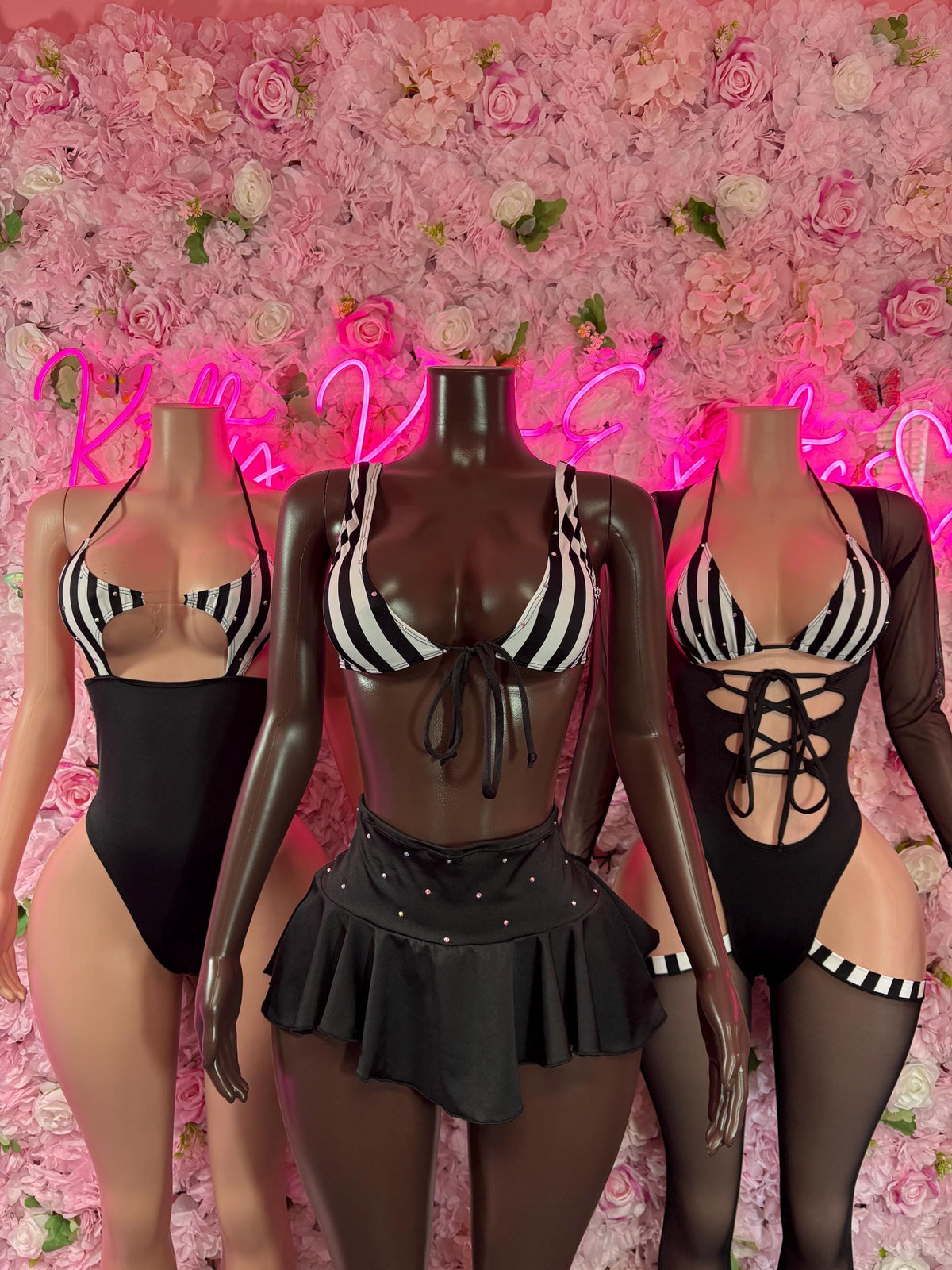 Black referee-style bodysuit with striped bra cups, front lacing and black skirt