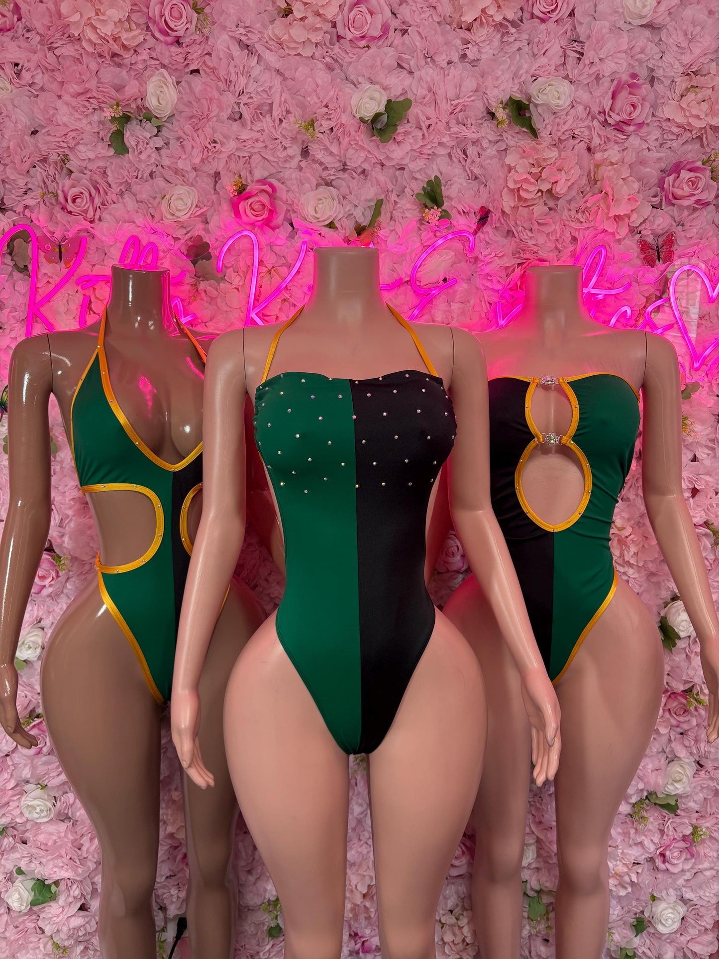 One-piece swimsuits group shot with green/black/yellow color-blocking and lace-up details