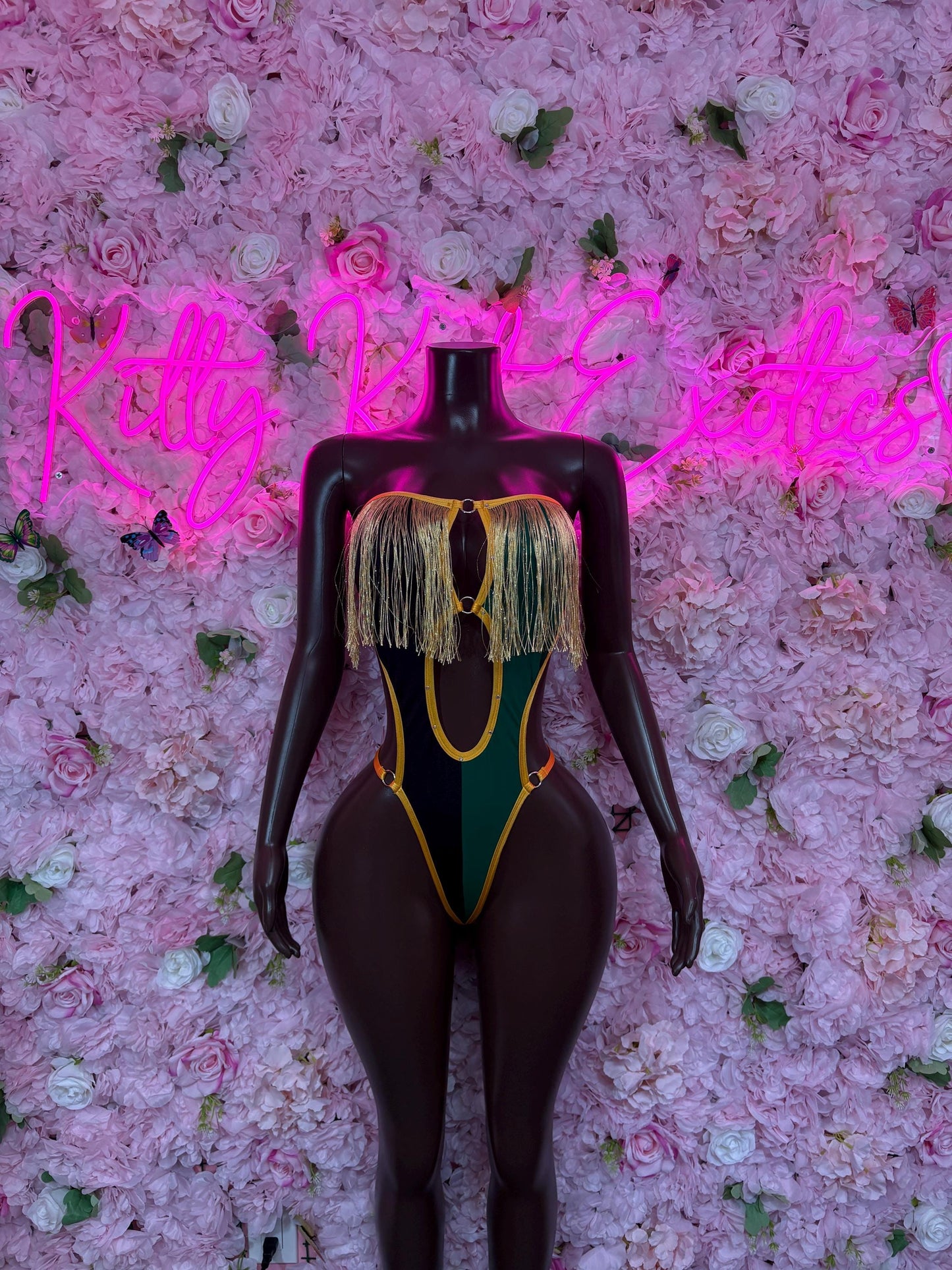 Jamaica flag bodysuit back, black one-piece with yellow-green trim and tassel detail