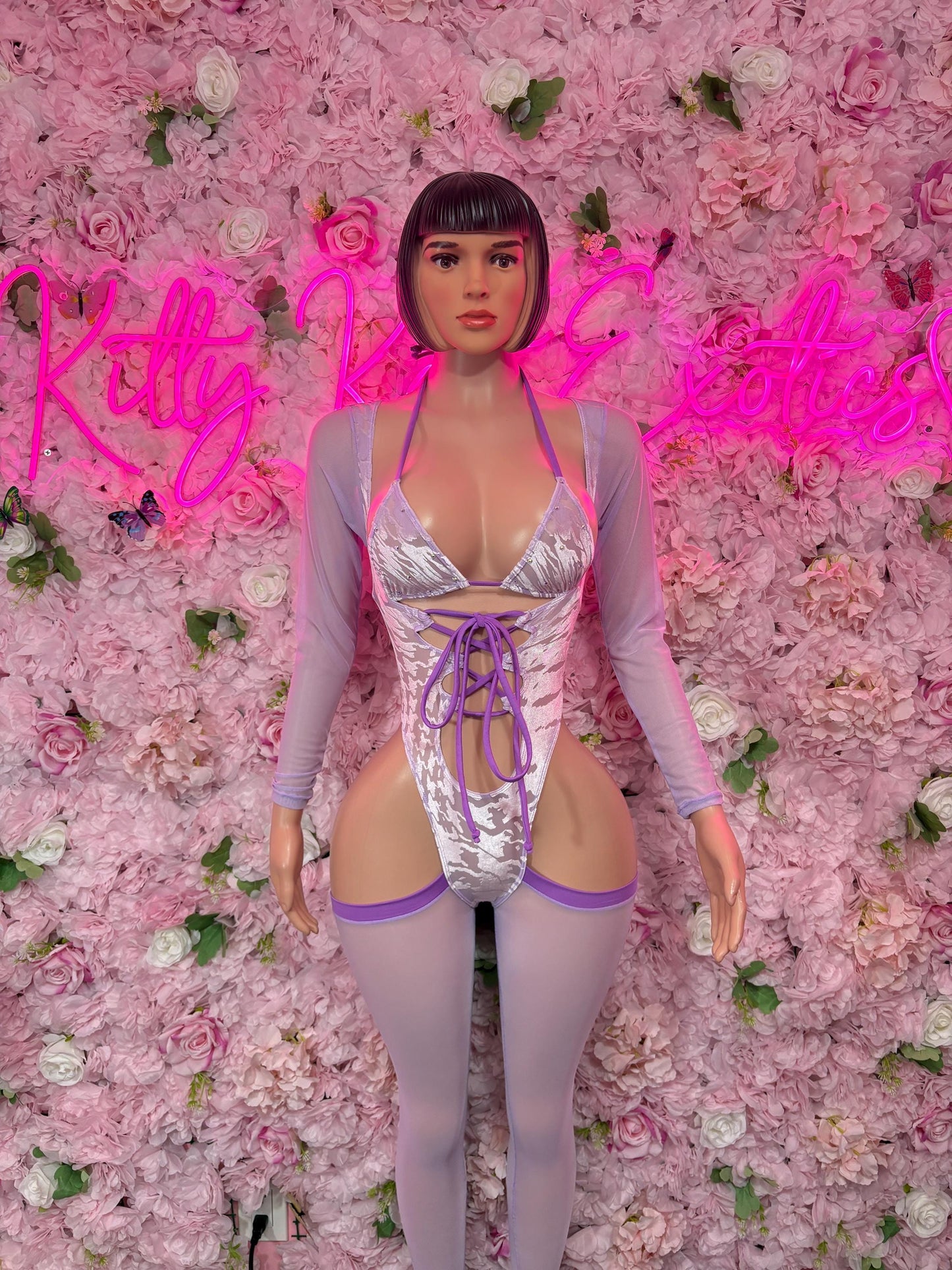 Purple-accent one-piece bodysuit with lace-up front and long sleeves