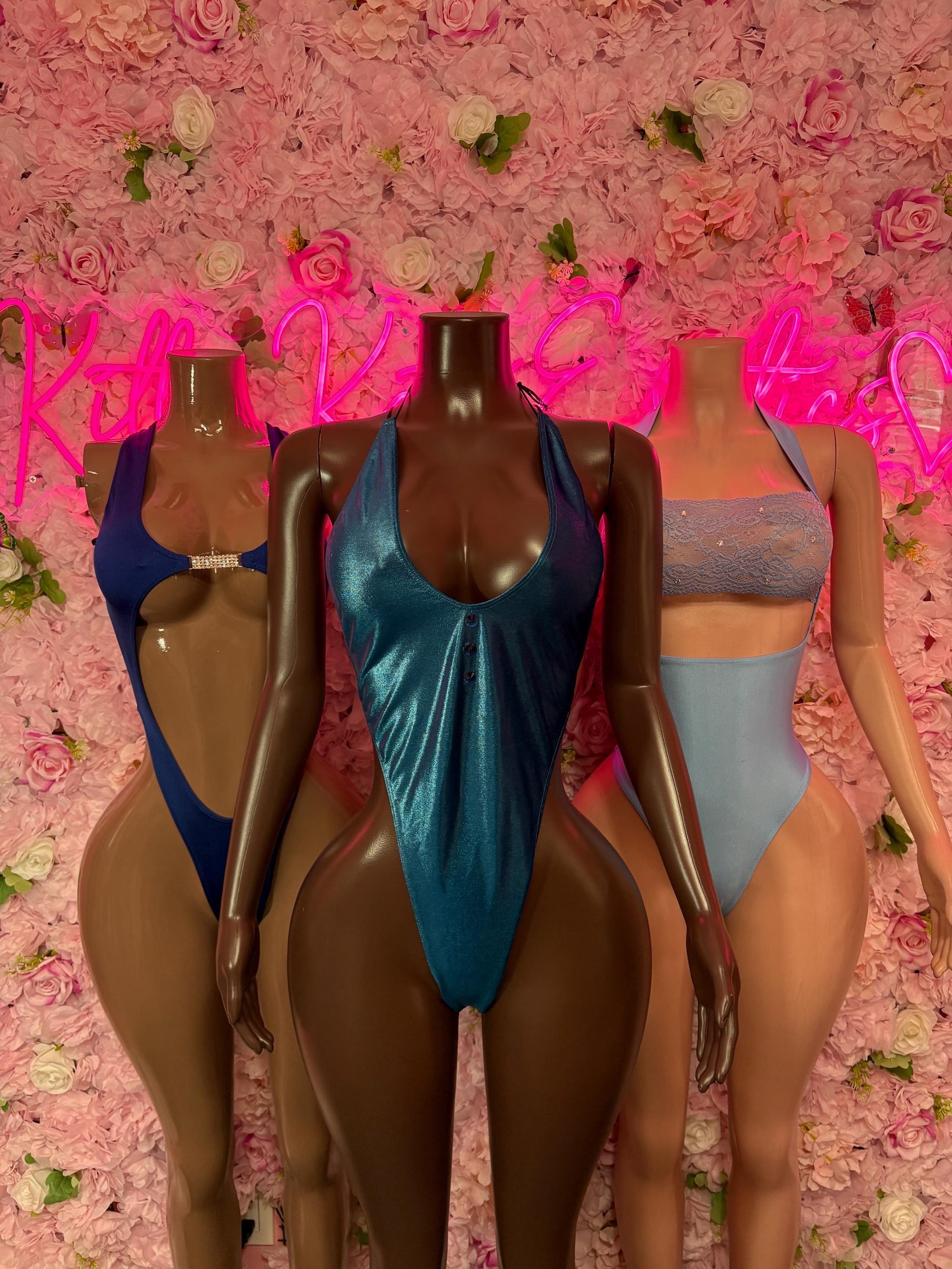 Blue one-piece dance bodysuit on mannequin, with scoop neckline and high-cut legs