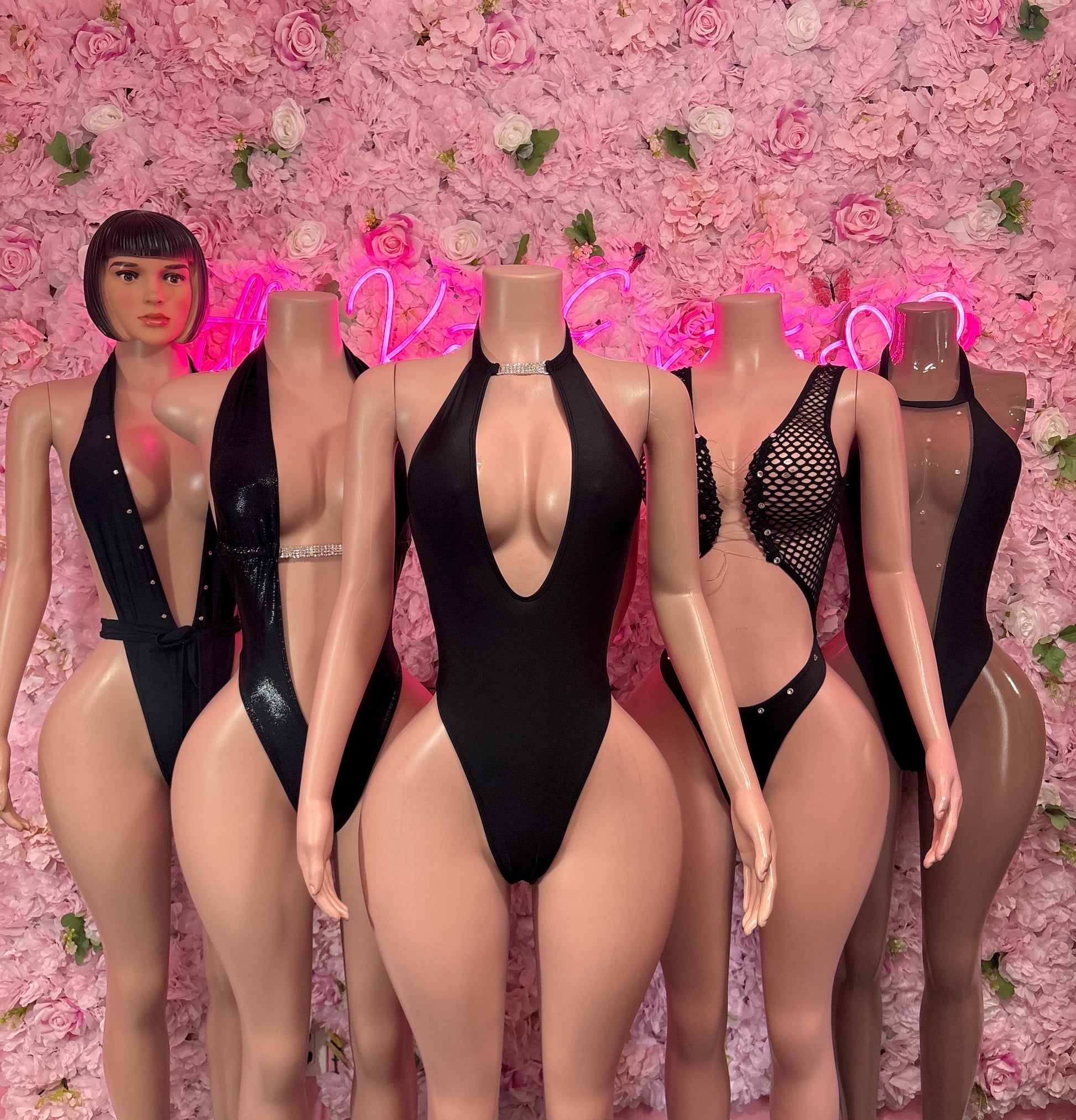 Black one-piece bodysuits with halter straps and plunging V fronts