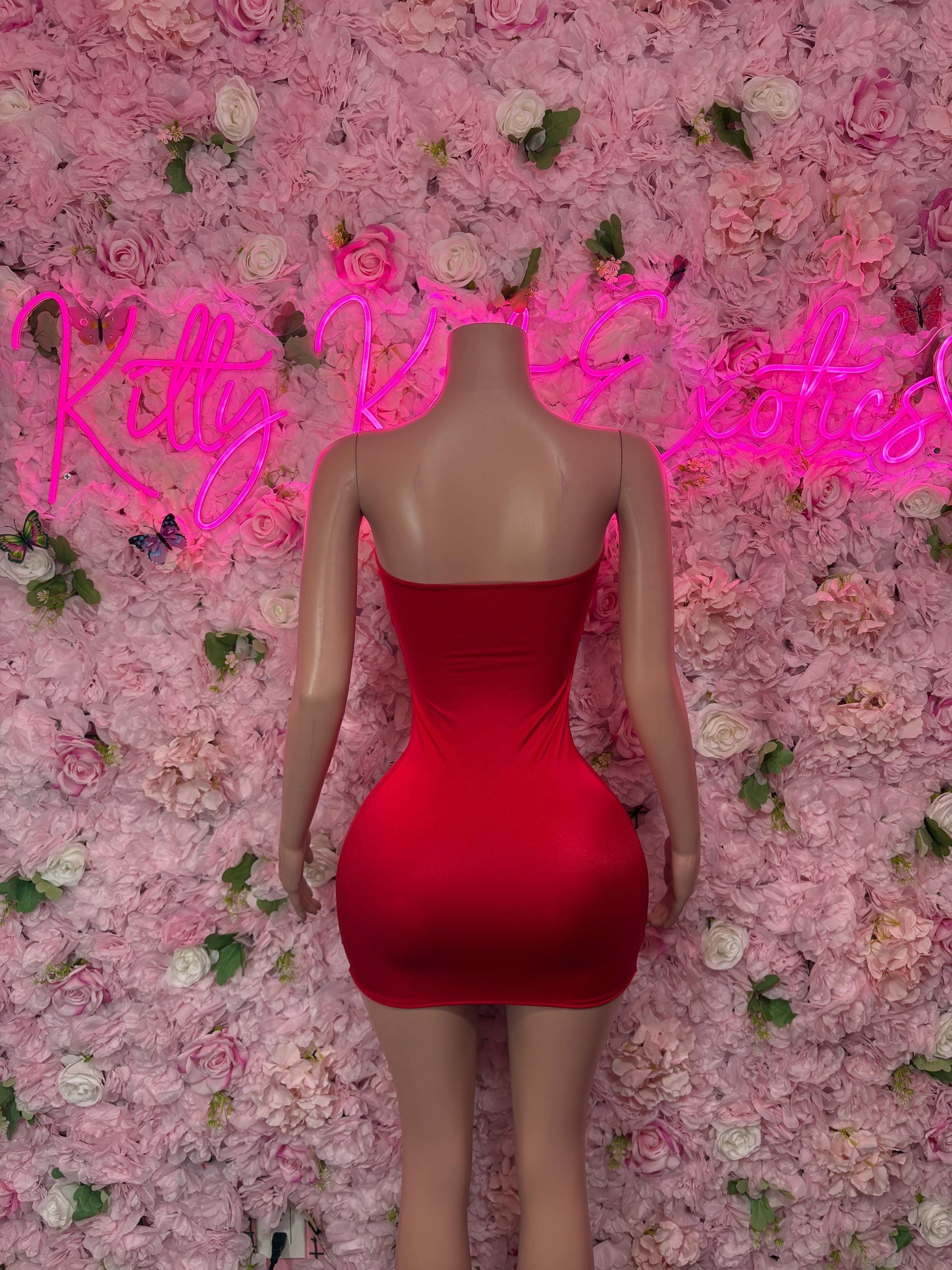 Back view of red one-piece dress with open back and narrow straps