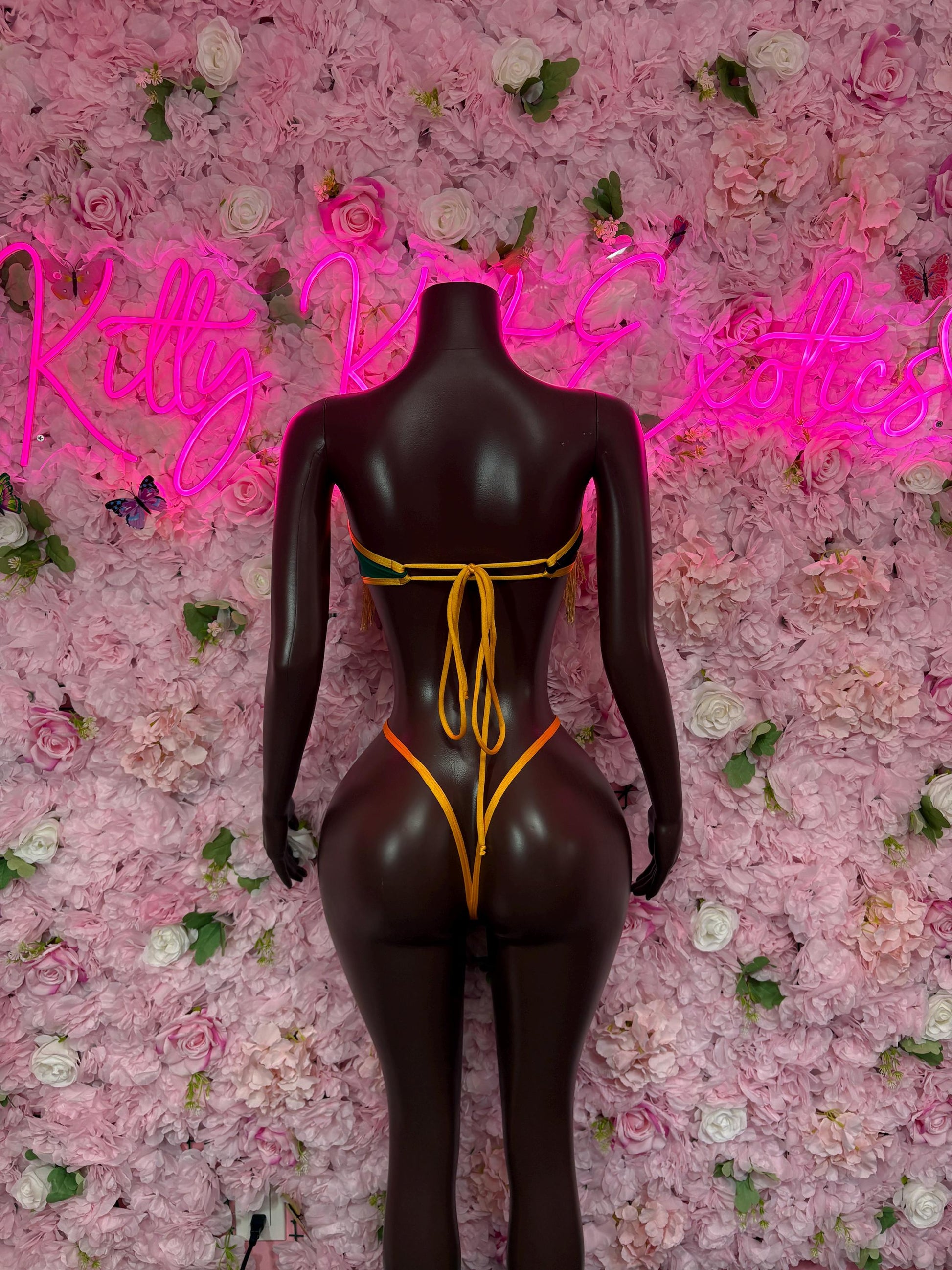 Jamaica flag bodysuit front, black one-piece swimsuit with yellow-green trim and ties