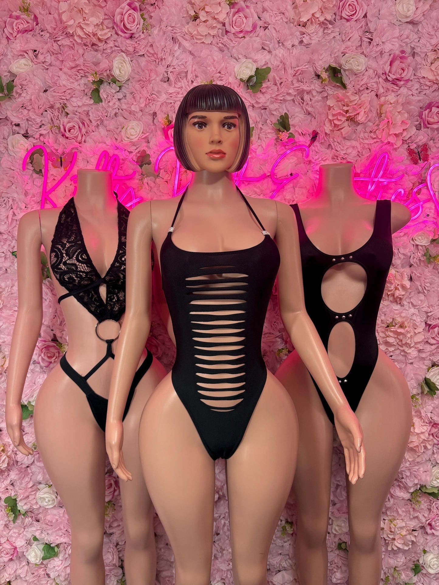 Black one-piece dance bodysuit with halter straps and ribbed torso cutout design