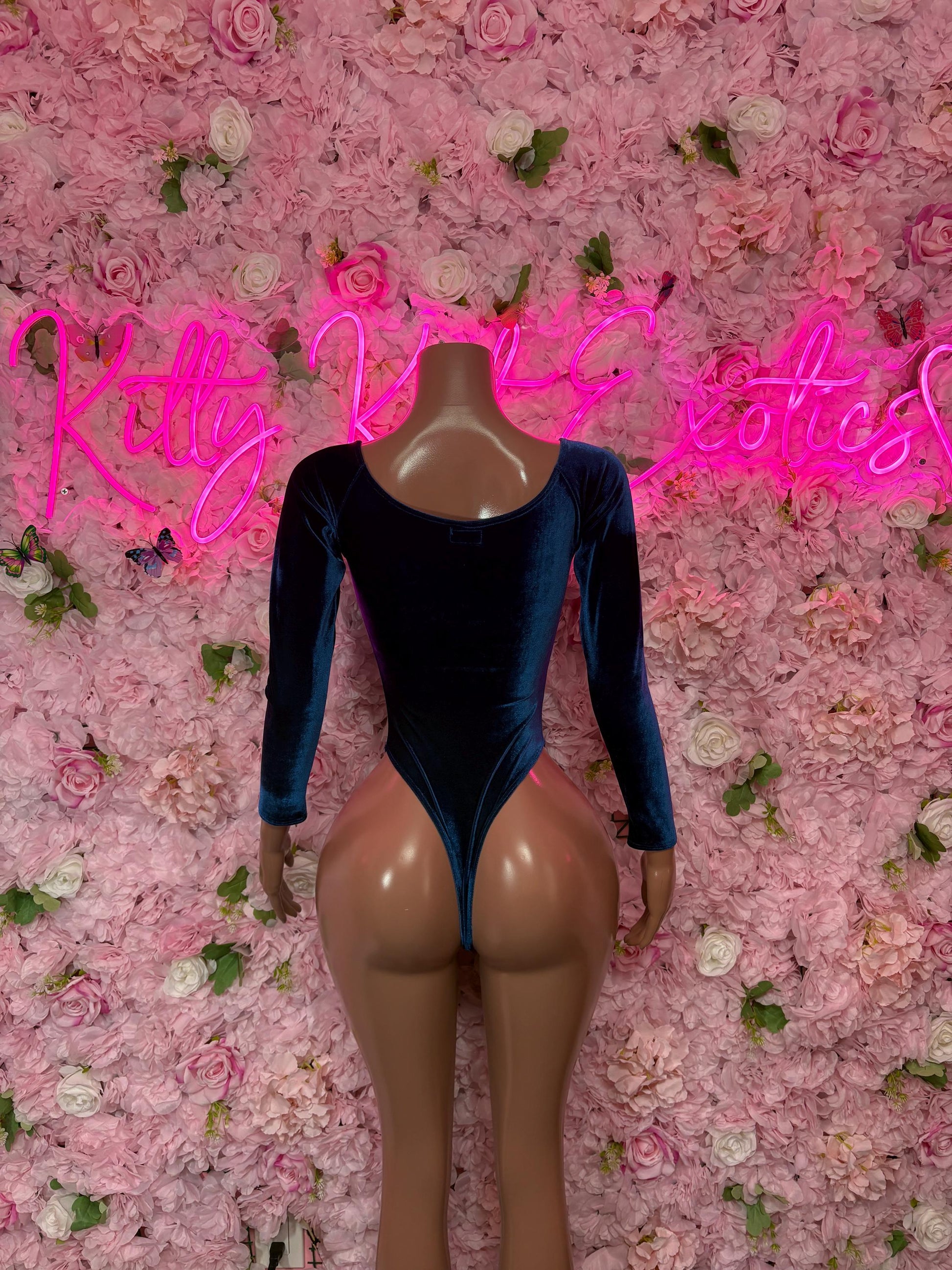 Blue velvet bodysuit with long sleeves and scoop neckline, high-cut leg openings