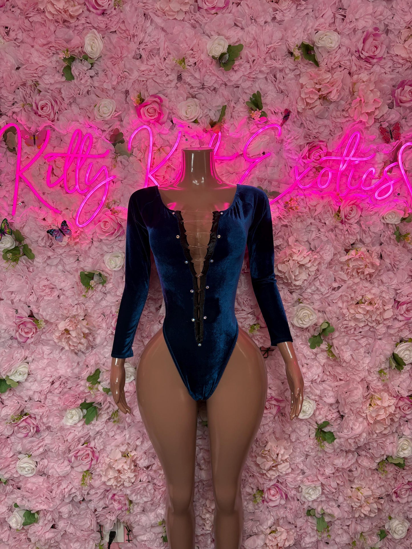 Blue velvet one-piece bodysuit with long sleeves, high-cut legs, and front zipper