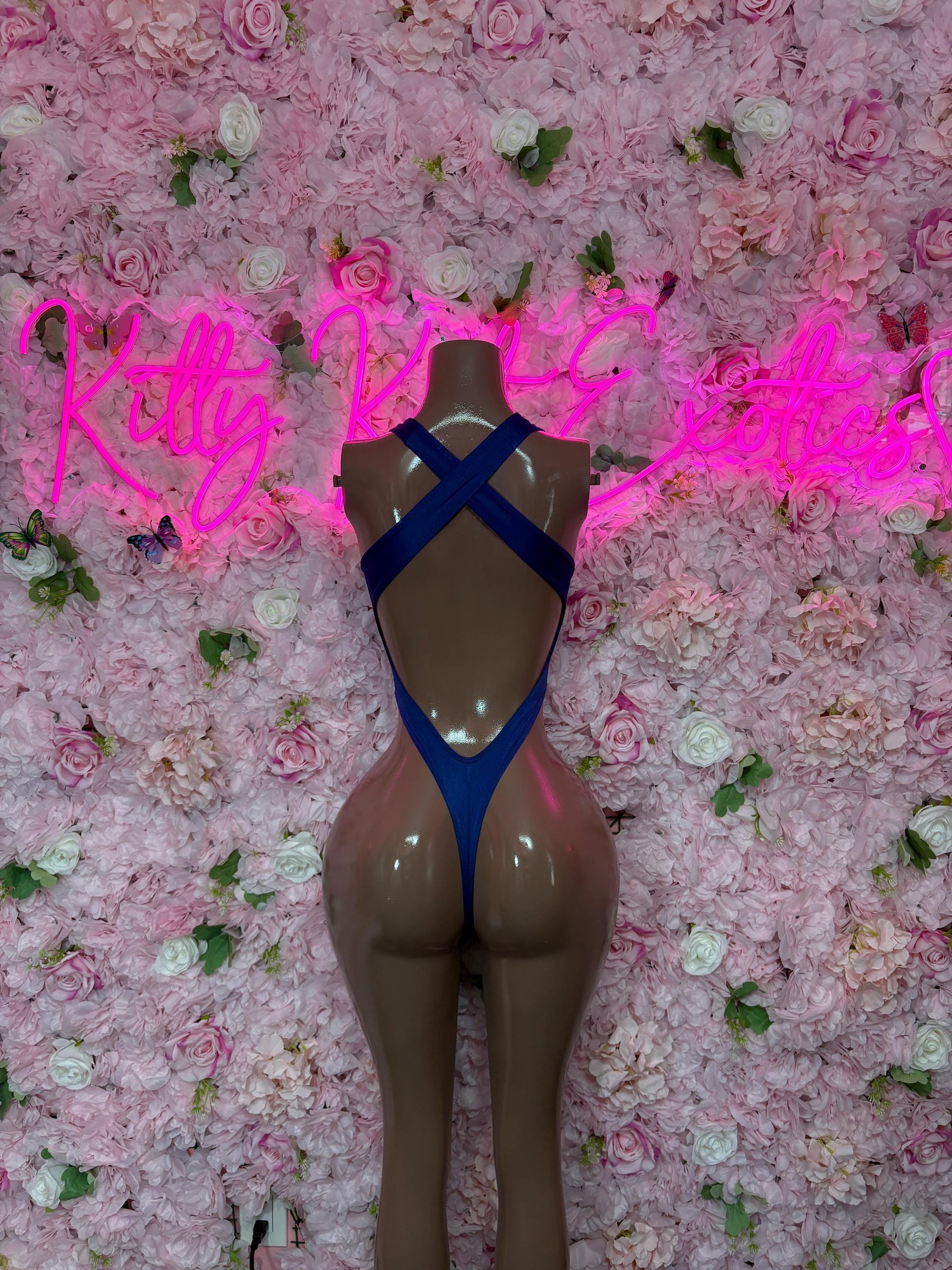 Blue one-piece bodysuit with crossed back straps and deep V front