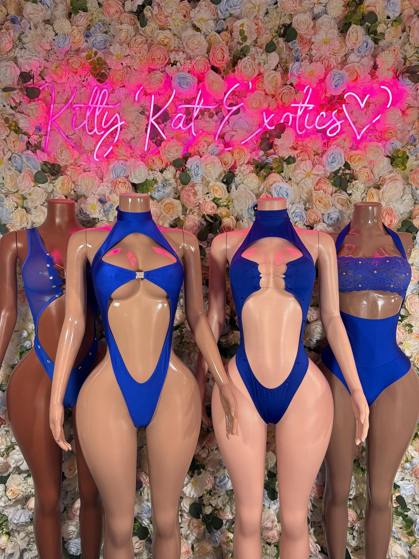 Set of blue bodysuits on mannequins, halter style with V-front cutout