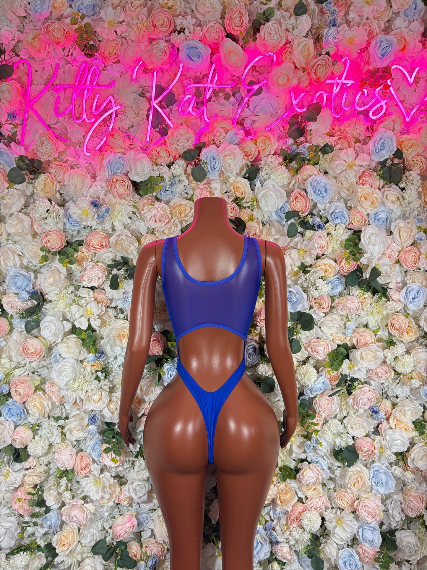 Blue one-piece bodysuit with open back and high-cut leg openings