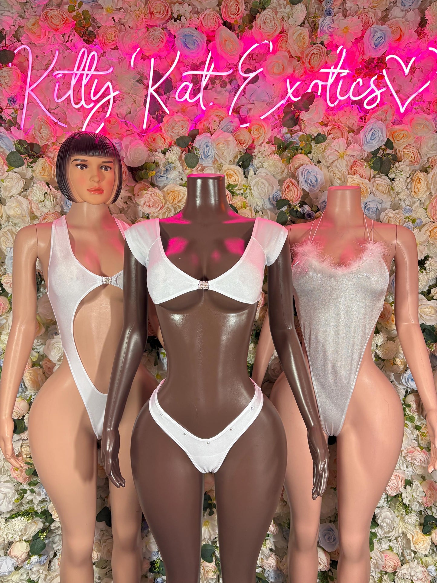 White strappy two-piece dancewear set on three mannequins, triangle bra and thong bottoms