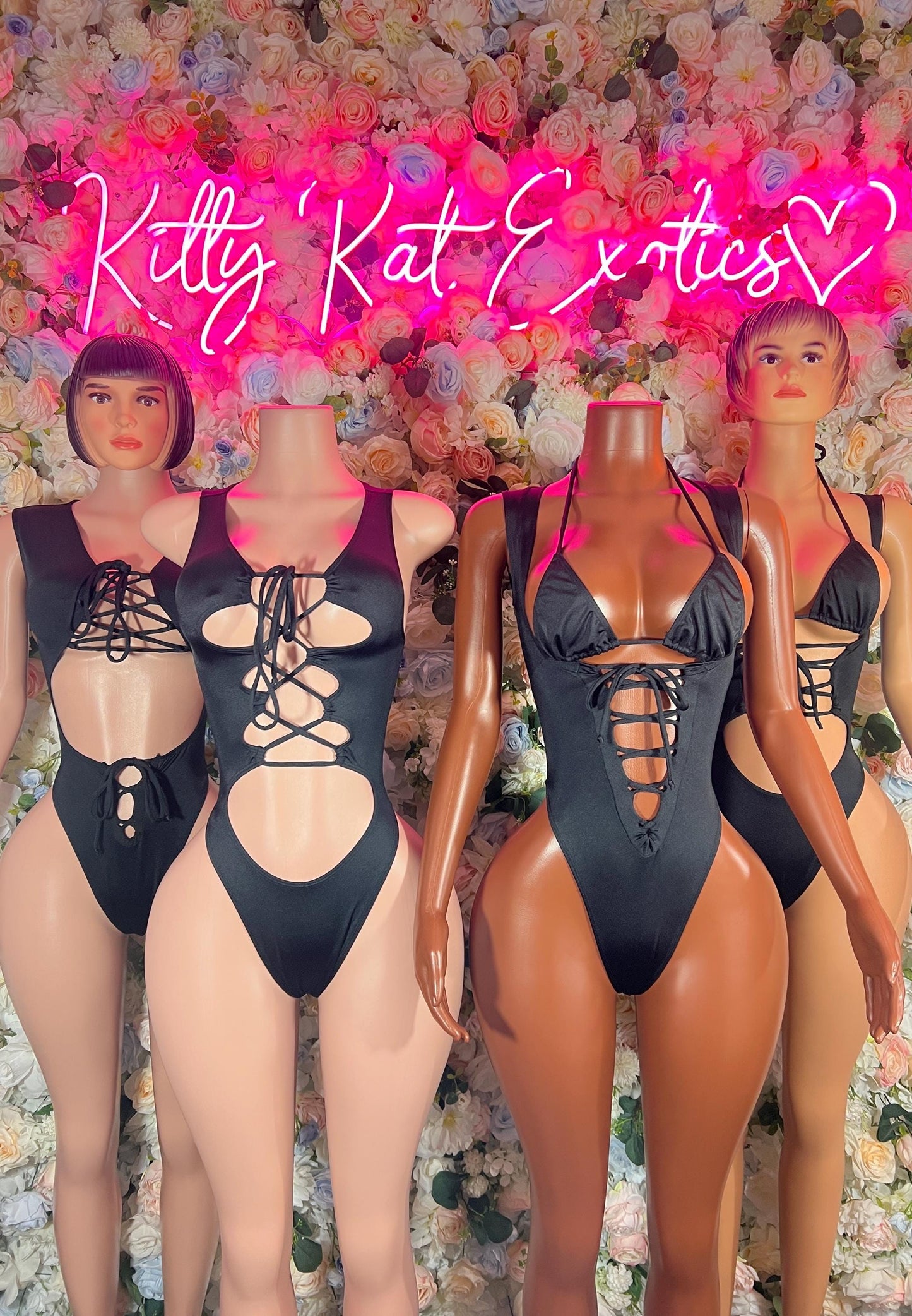 Black lace-up bodysuit with triangle cups, cutout sides, and open back
