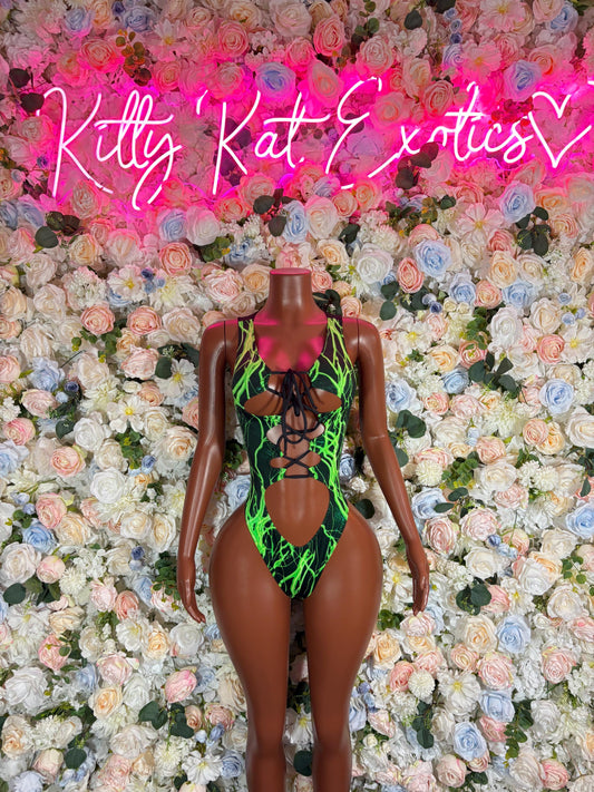 Green one-piece bodysuit with crisscross black lace-up straps, front view