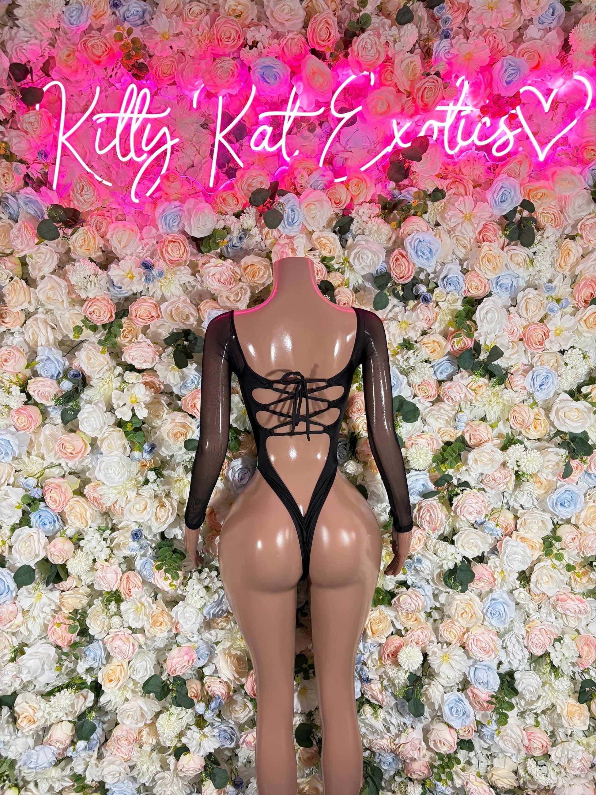 Green electric one-piece bodysuit with long sleeves, crisscross lace under bust