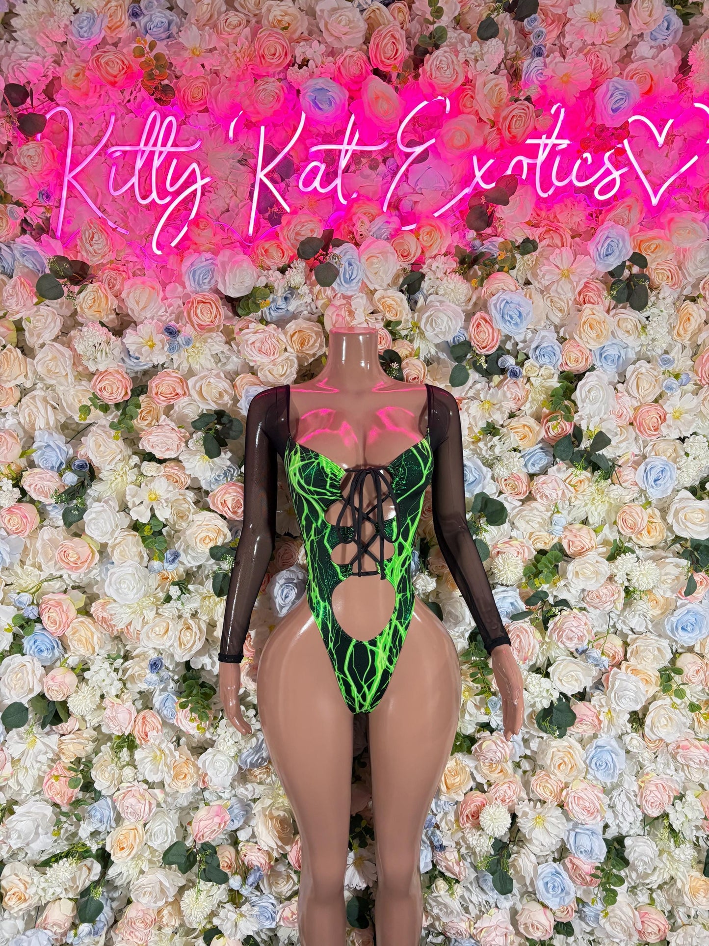Green electric bodysuit with long sleeves, crisscross lace-up front and cutout back