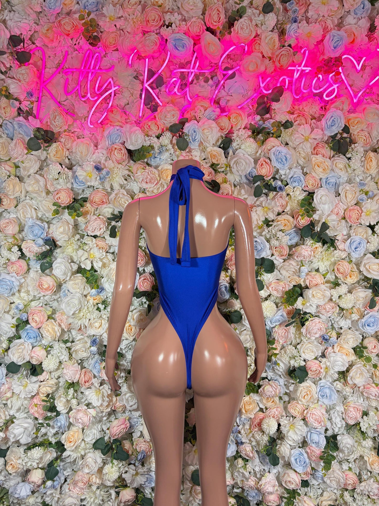 Blue one-piece bodysuit with open back and halter straps