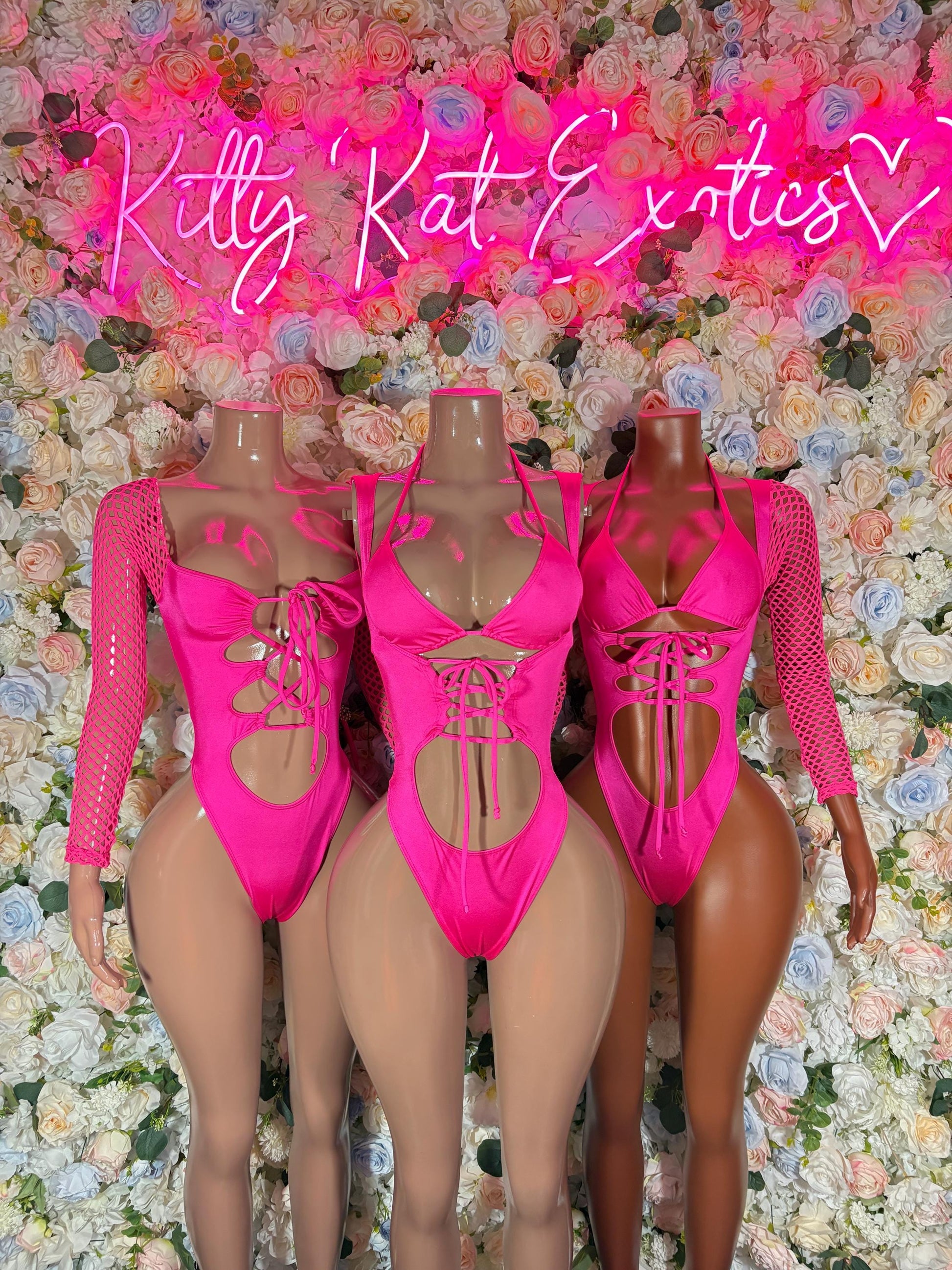 Pink lace-up bodysuit with sheer long sleeves, front cutout and back lacing